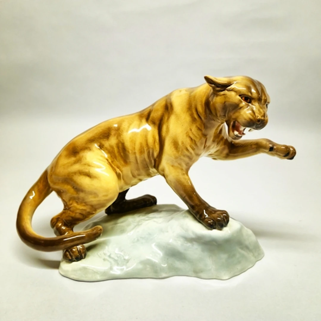 Beswick figure of a puma, glazed in brown with left paw rais...