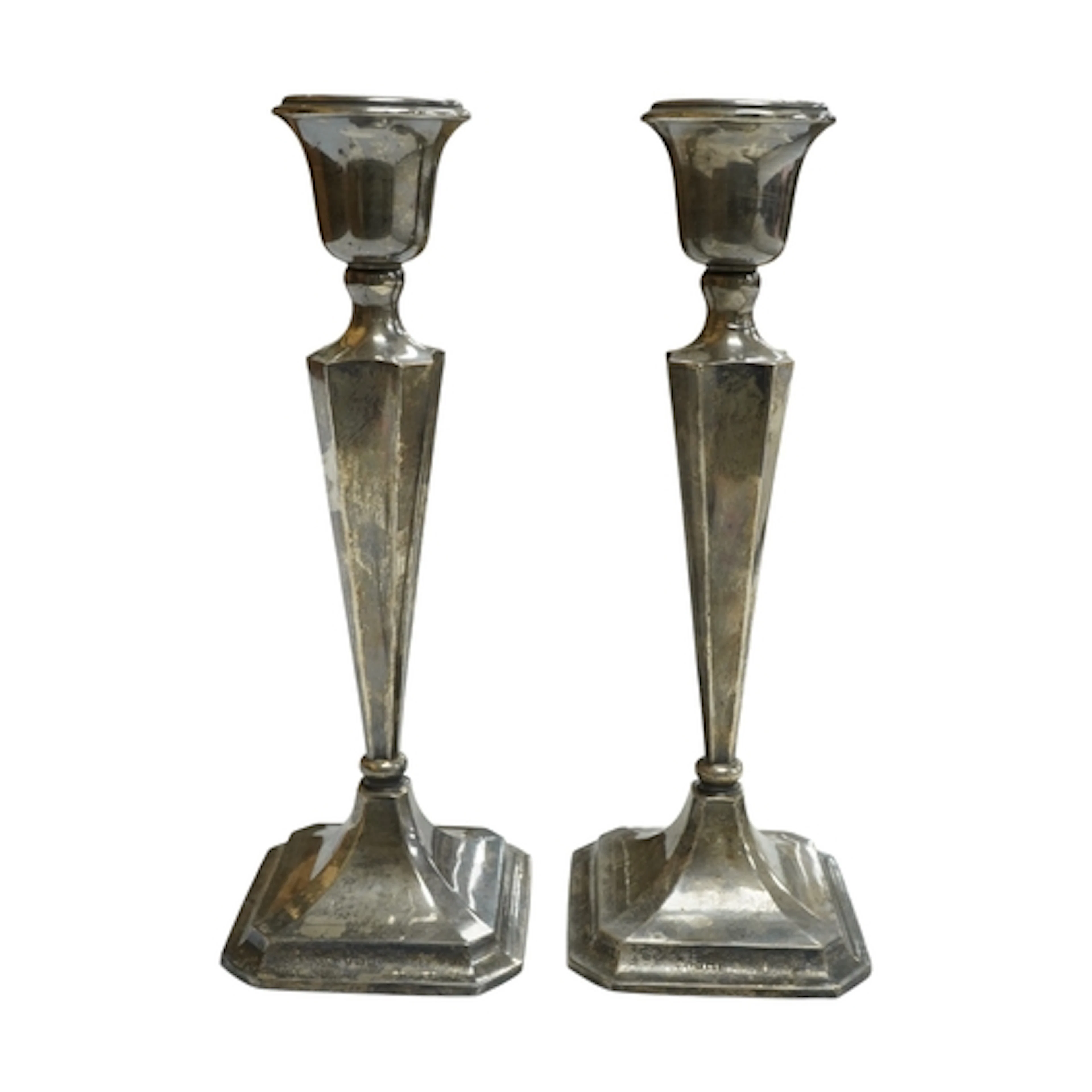A pair of George V silver mounted candlesticks, of panelled ...