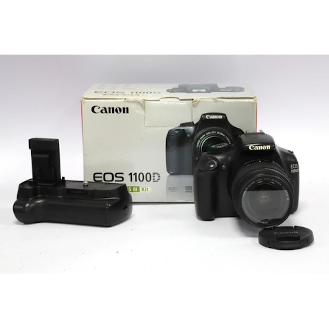Canon EOS 1100D DSLR Camera with attached EF-S 18-55mm f/3.5...