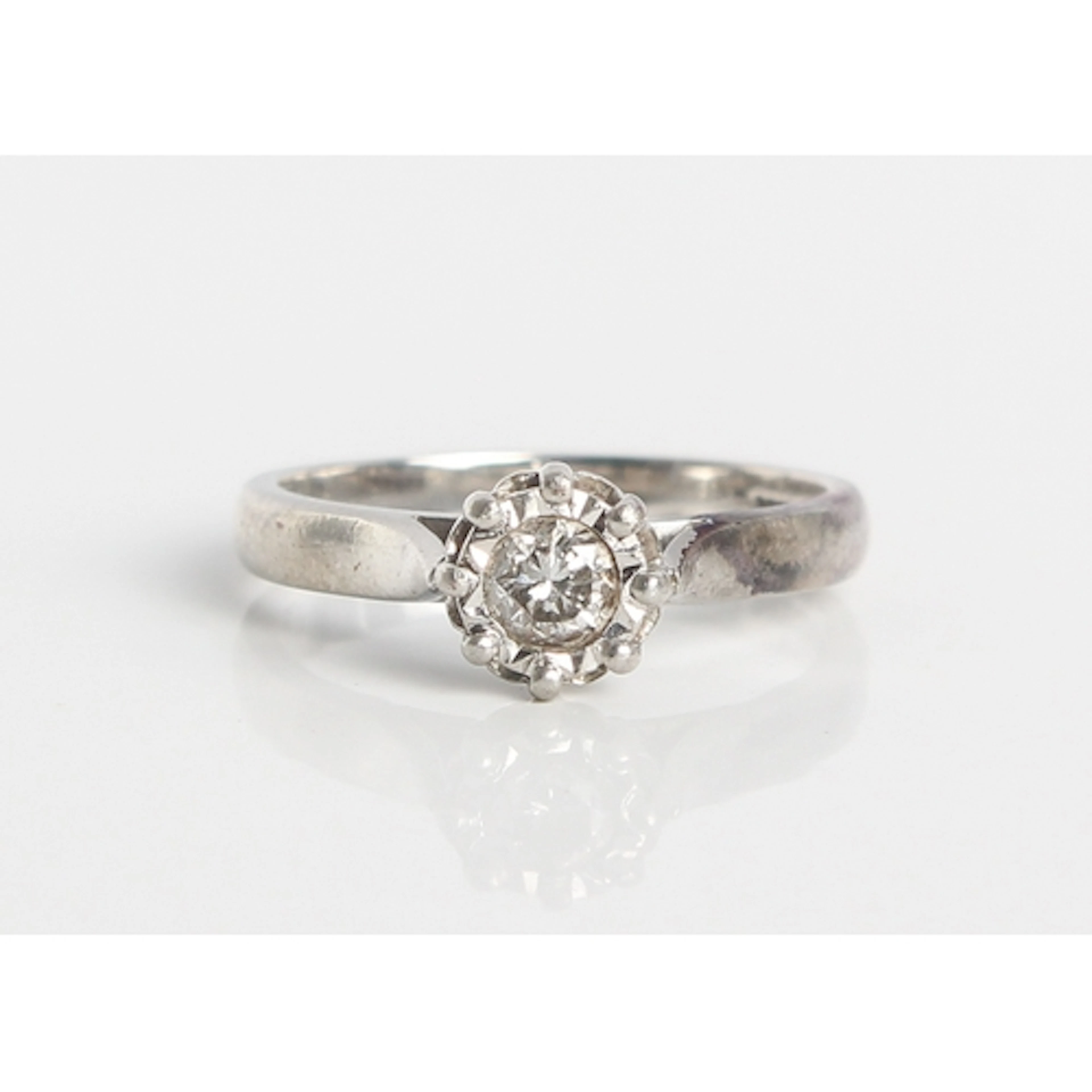 A platinum and diamond engagement ring - with a single brill...