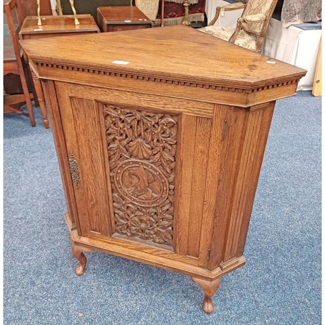 EARLY 20TH CENTURY OAK CORNER CABINET WITH CARVED PANEL DOOR...