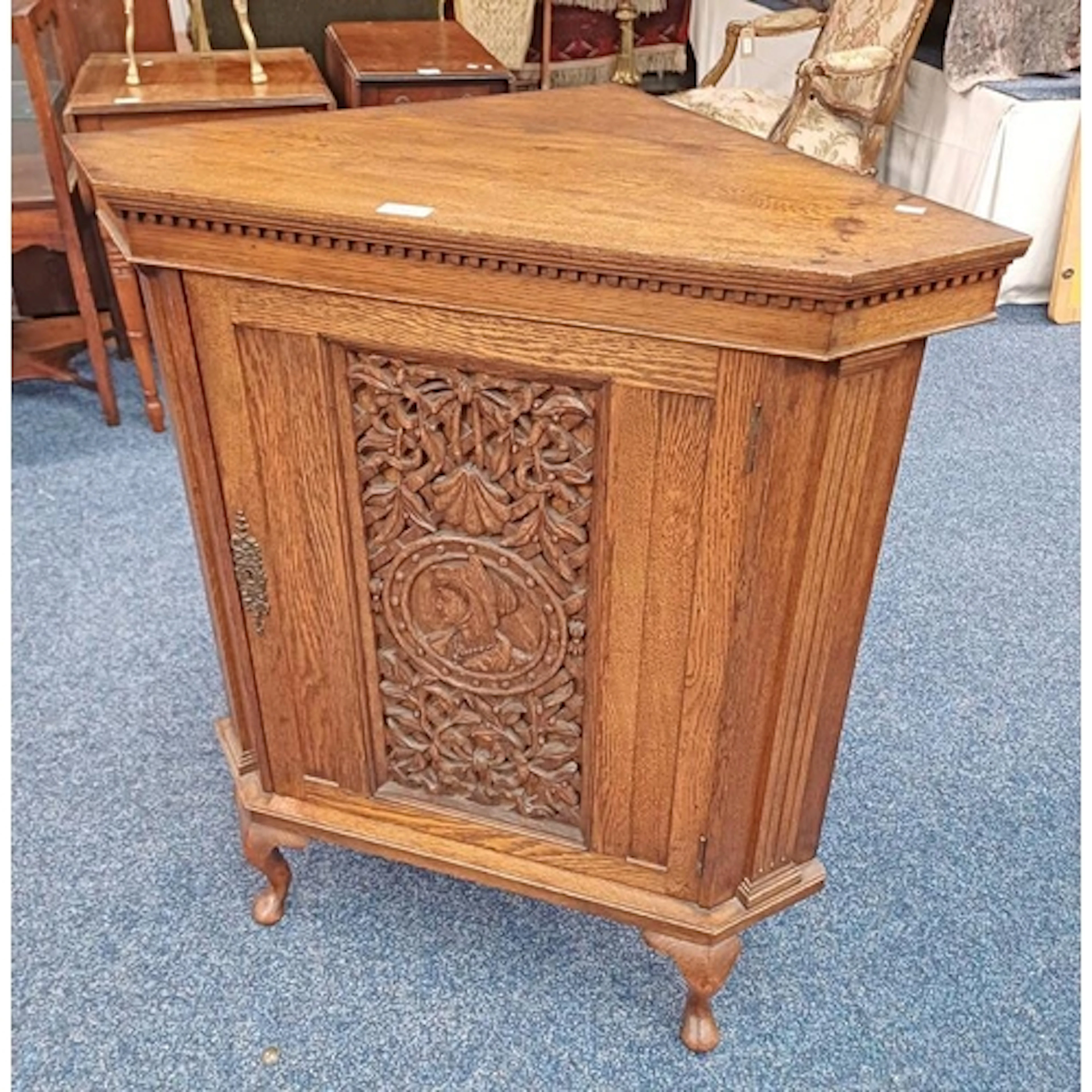 EARLY 20TH CENTURY OAK CORNER CABINET WITH CARVED PANEL DOOR...