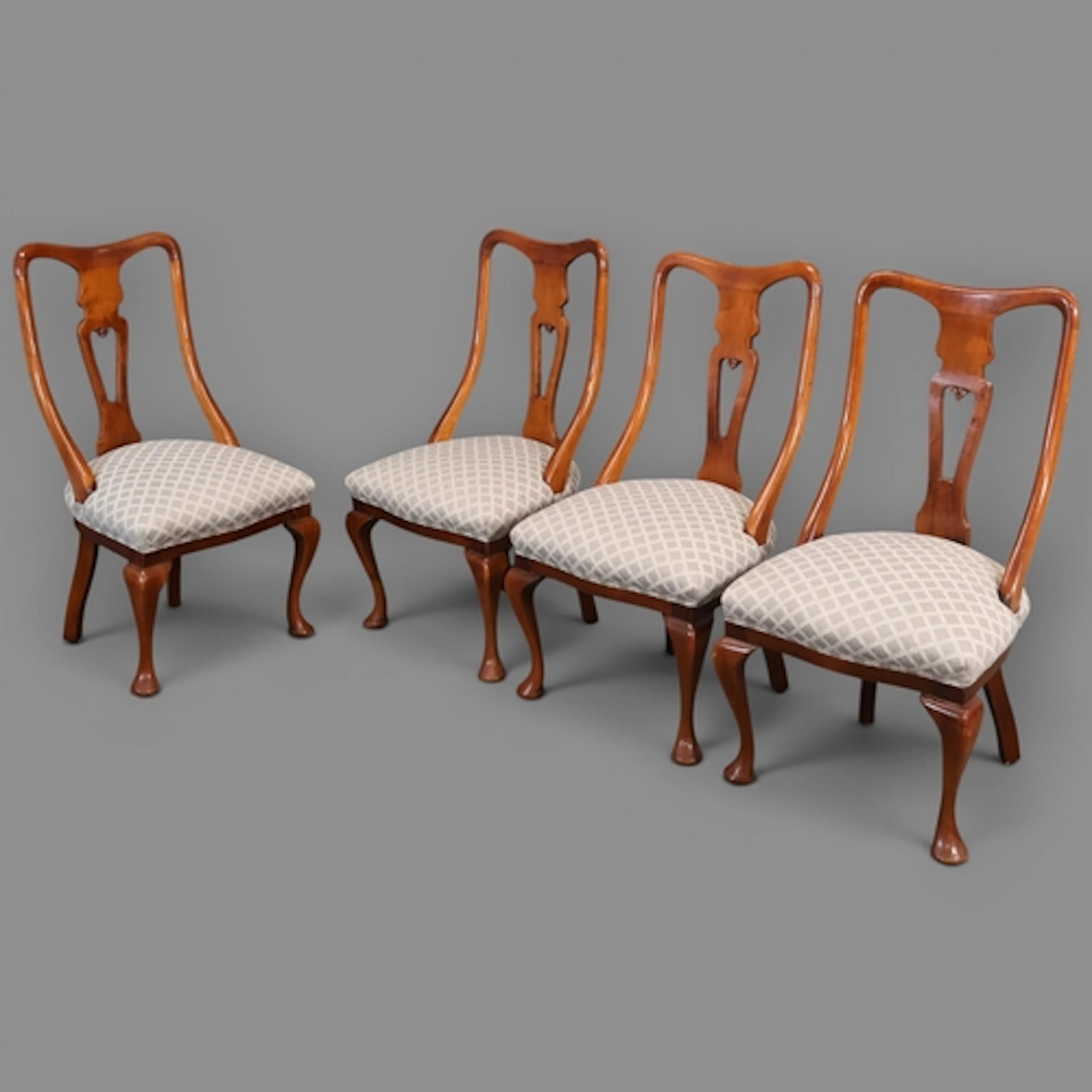 A set of four mahogany and upholstered Queen Anne style dini...