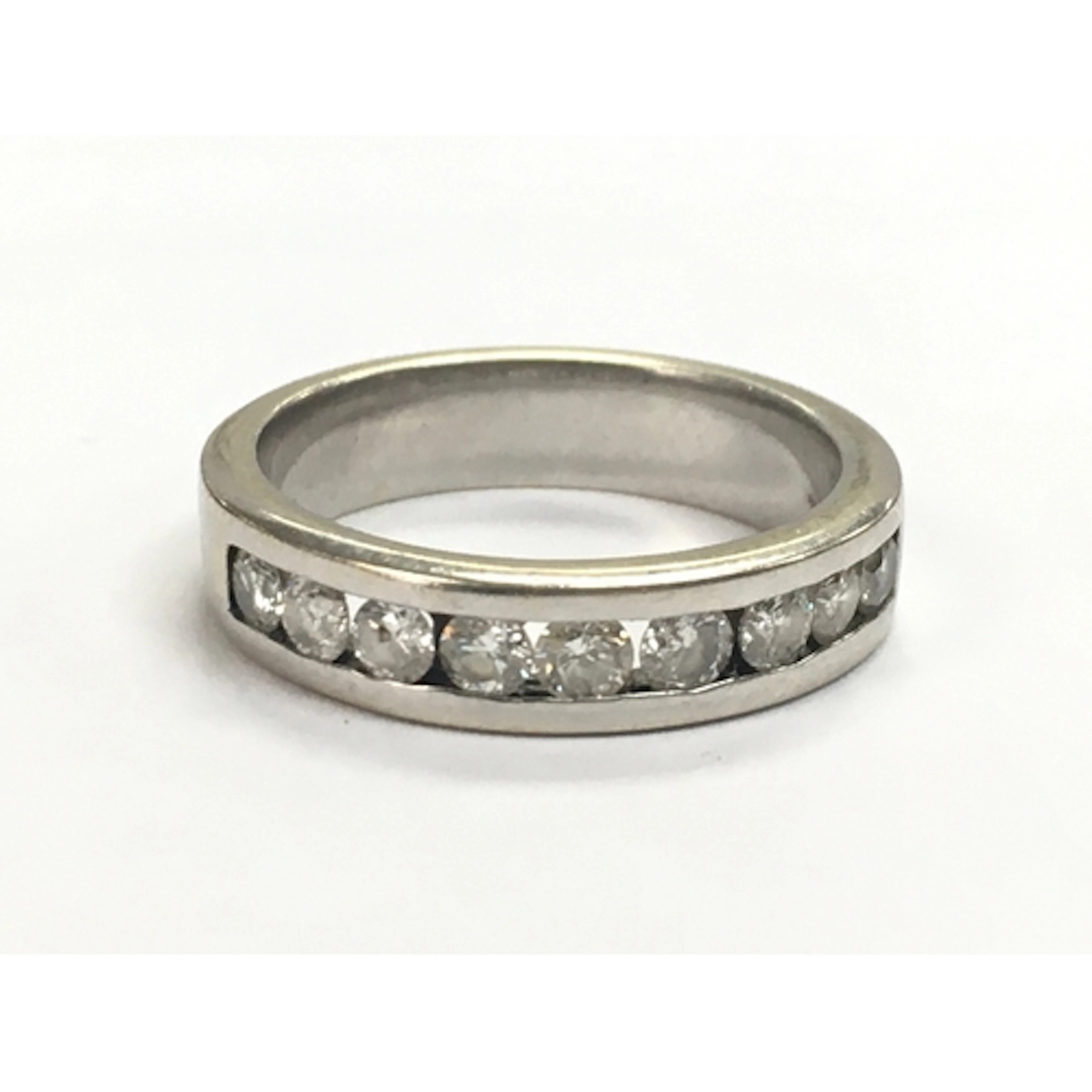 A diamond stone set 14ct white gold half eternity ring. 4.3g...