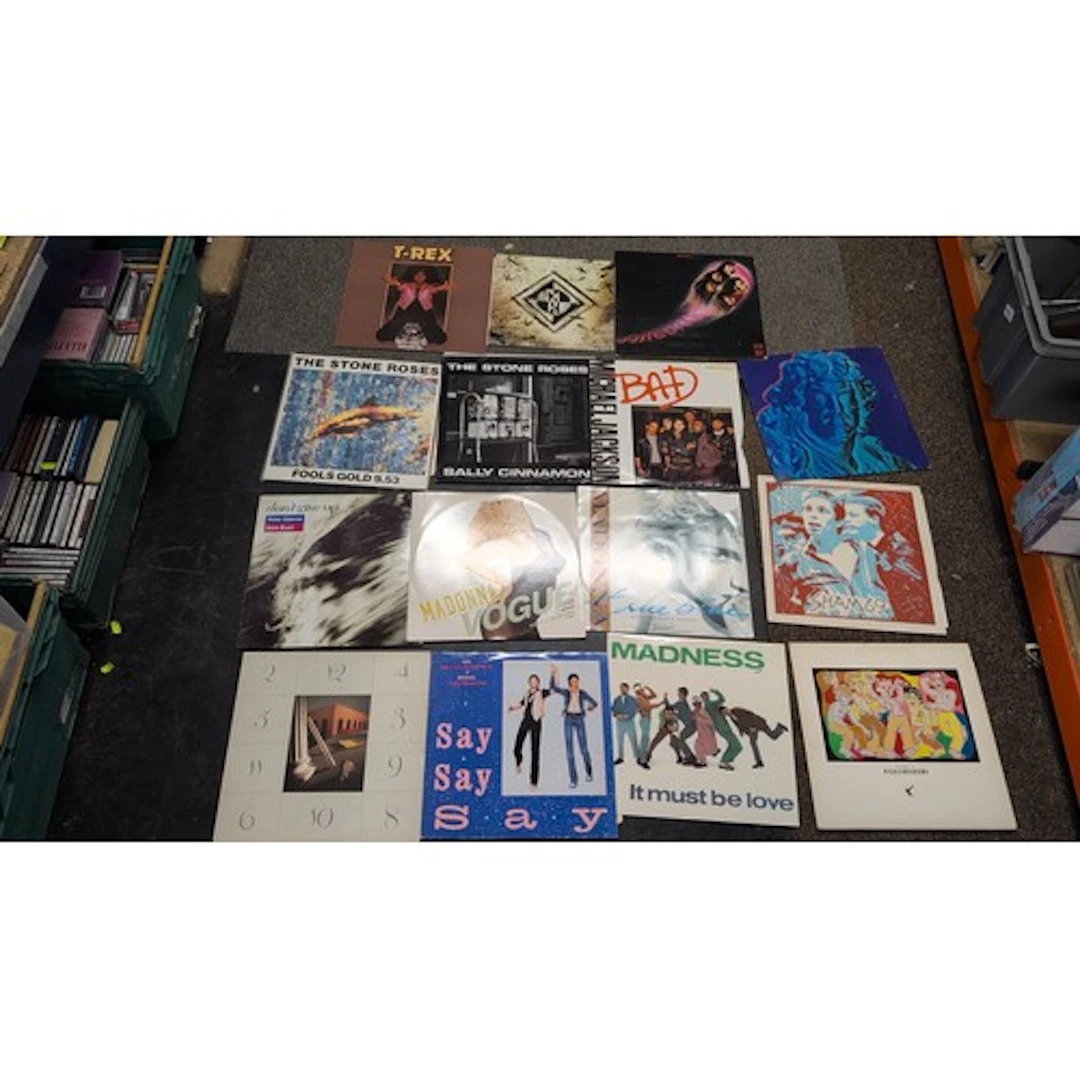 A collection of pop and rock vinyl records, including releas...
