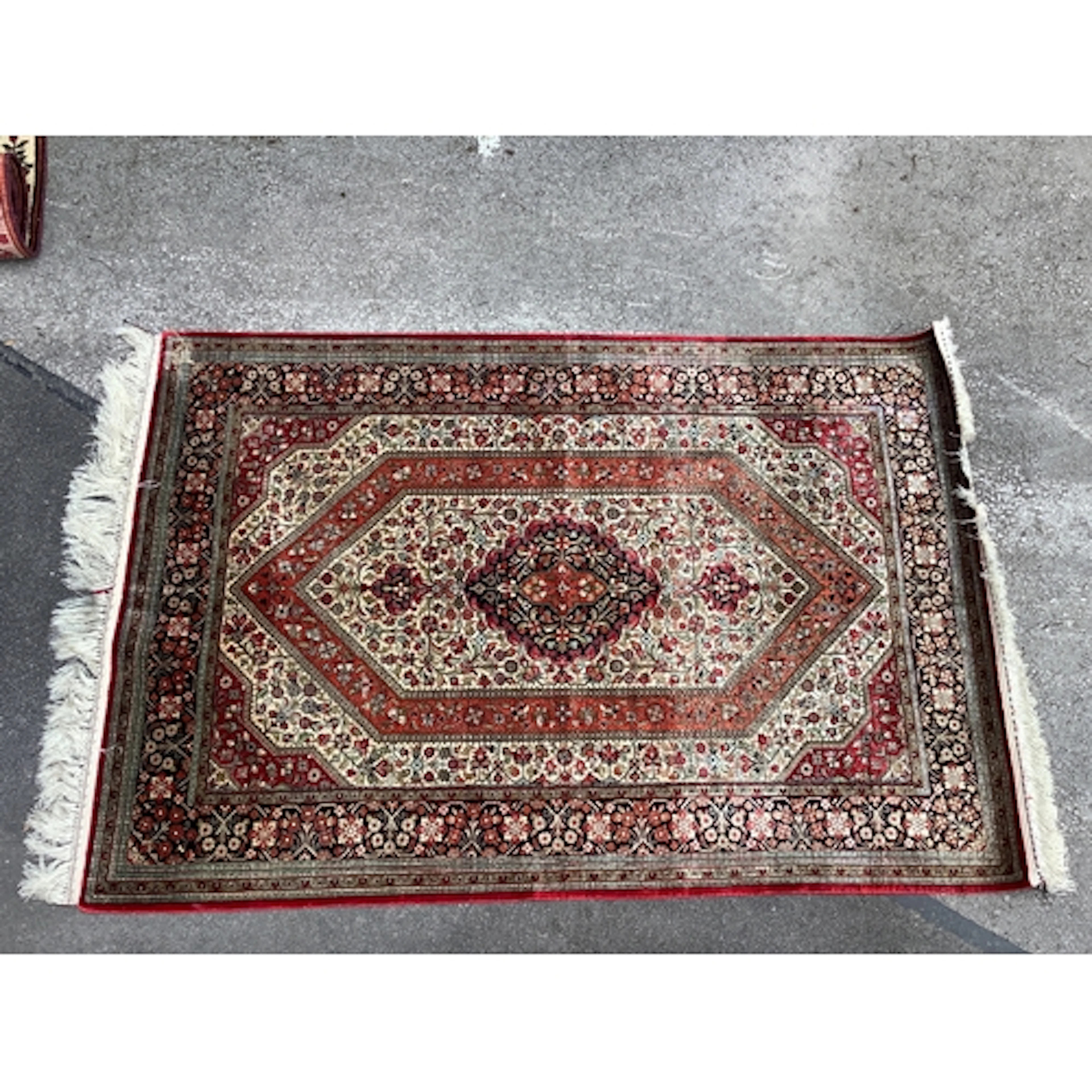 A Silk Persian Ghom Rug, decorated with floral patterns on a...