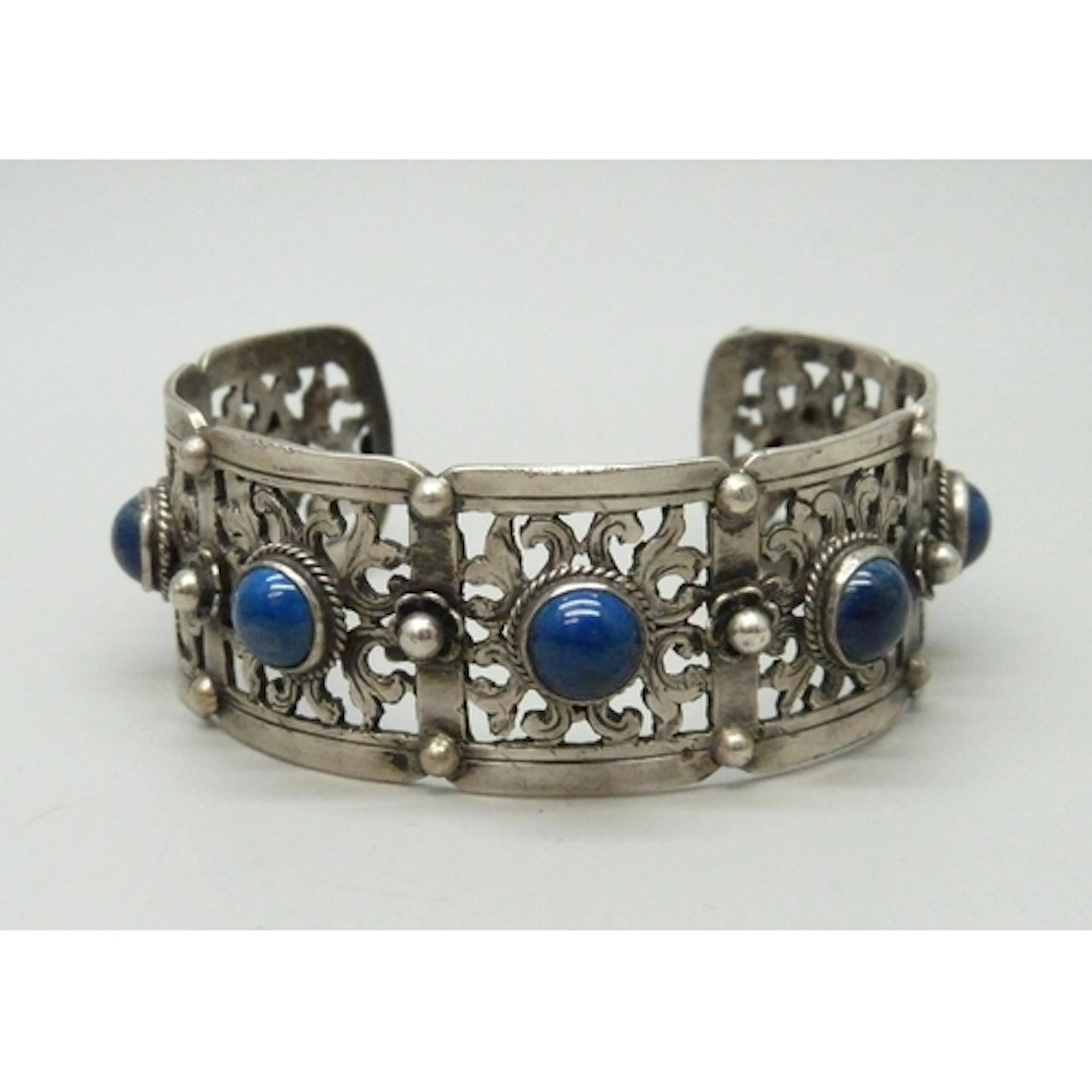 A white metal bangle set with blue cabochon stones, 36g, 6 x...