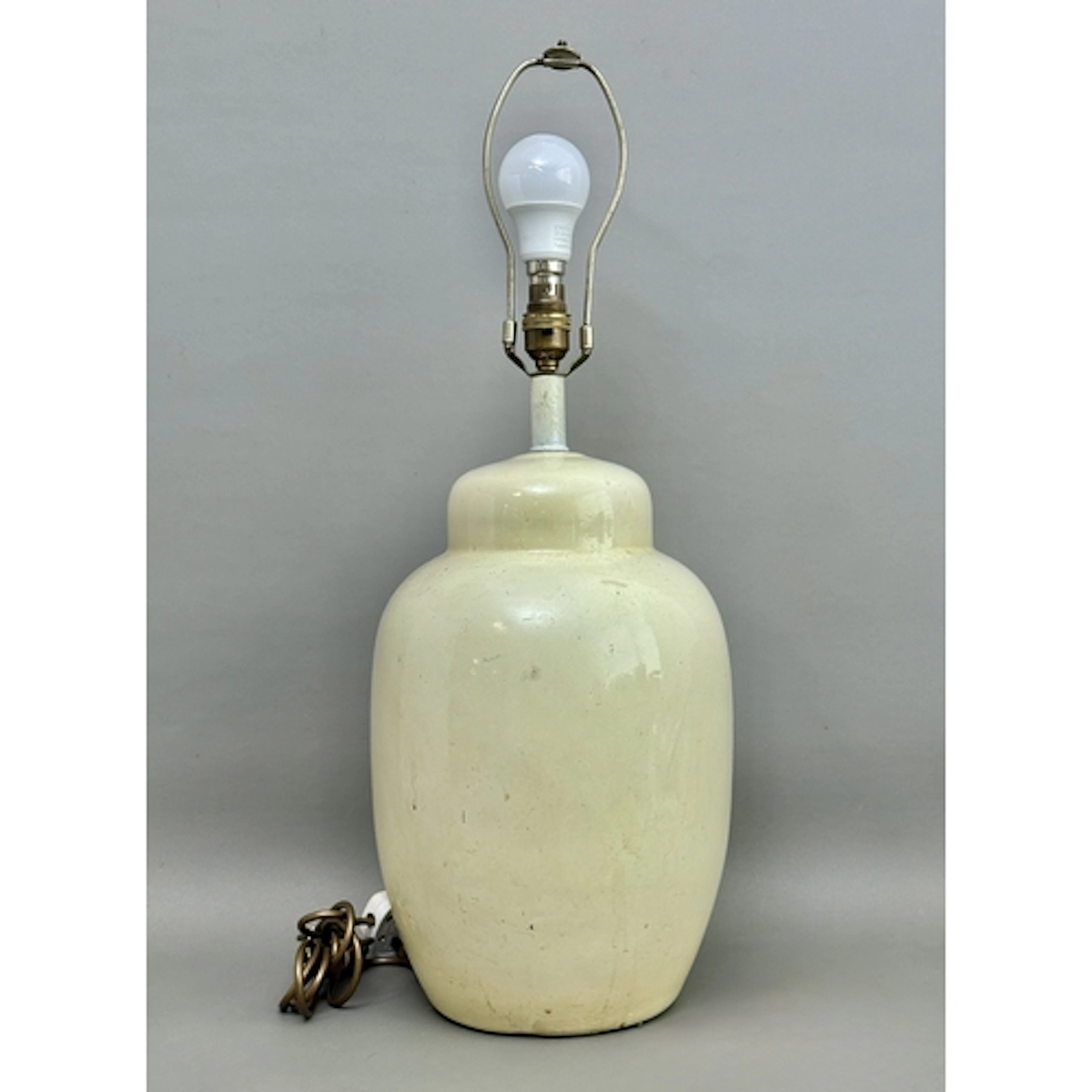 A ceramic cream glazed ginger jar style lamp - some cracks a...