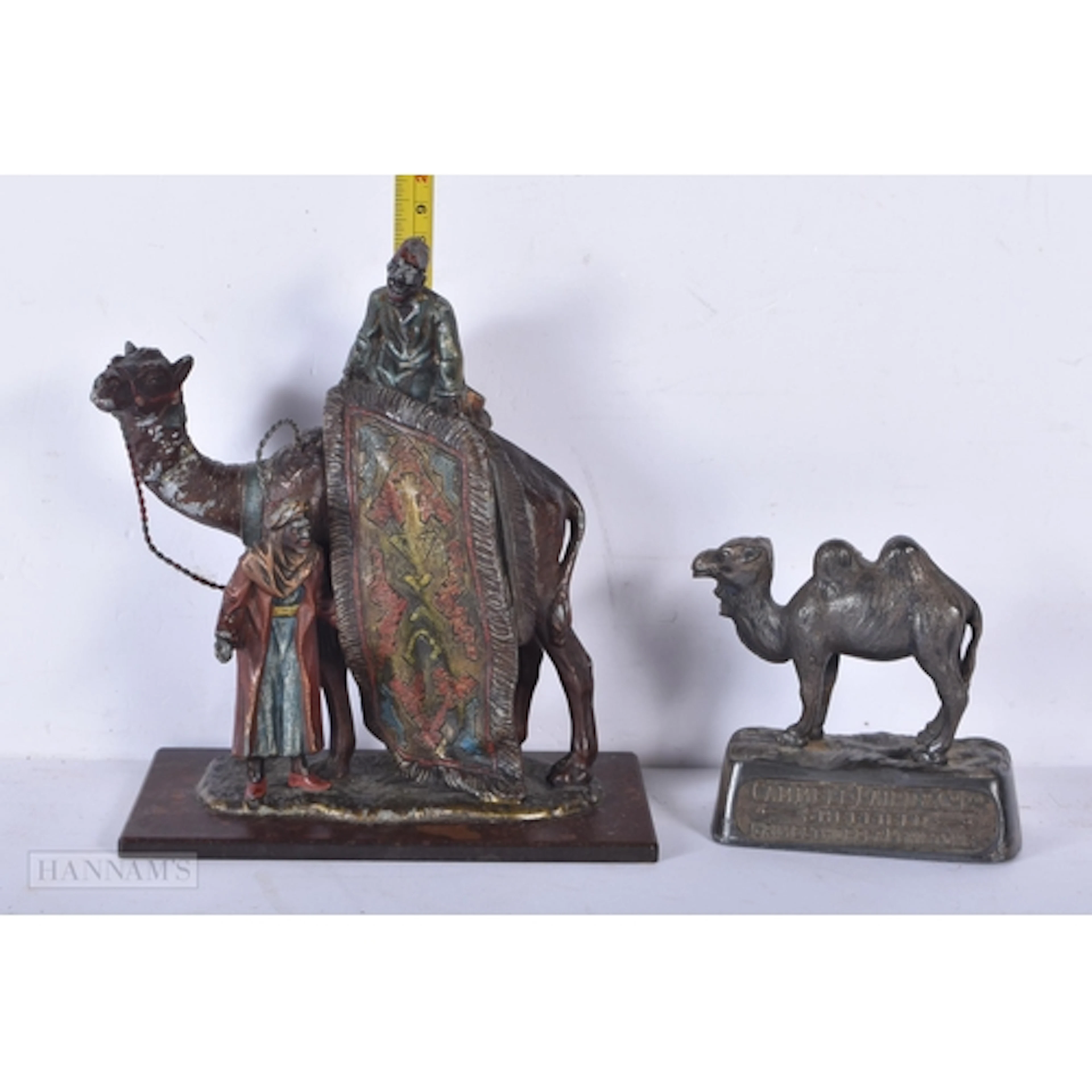 A Bergman style spelter Arab rug seller on a camel together ...