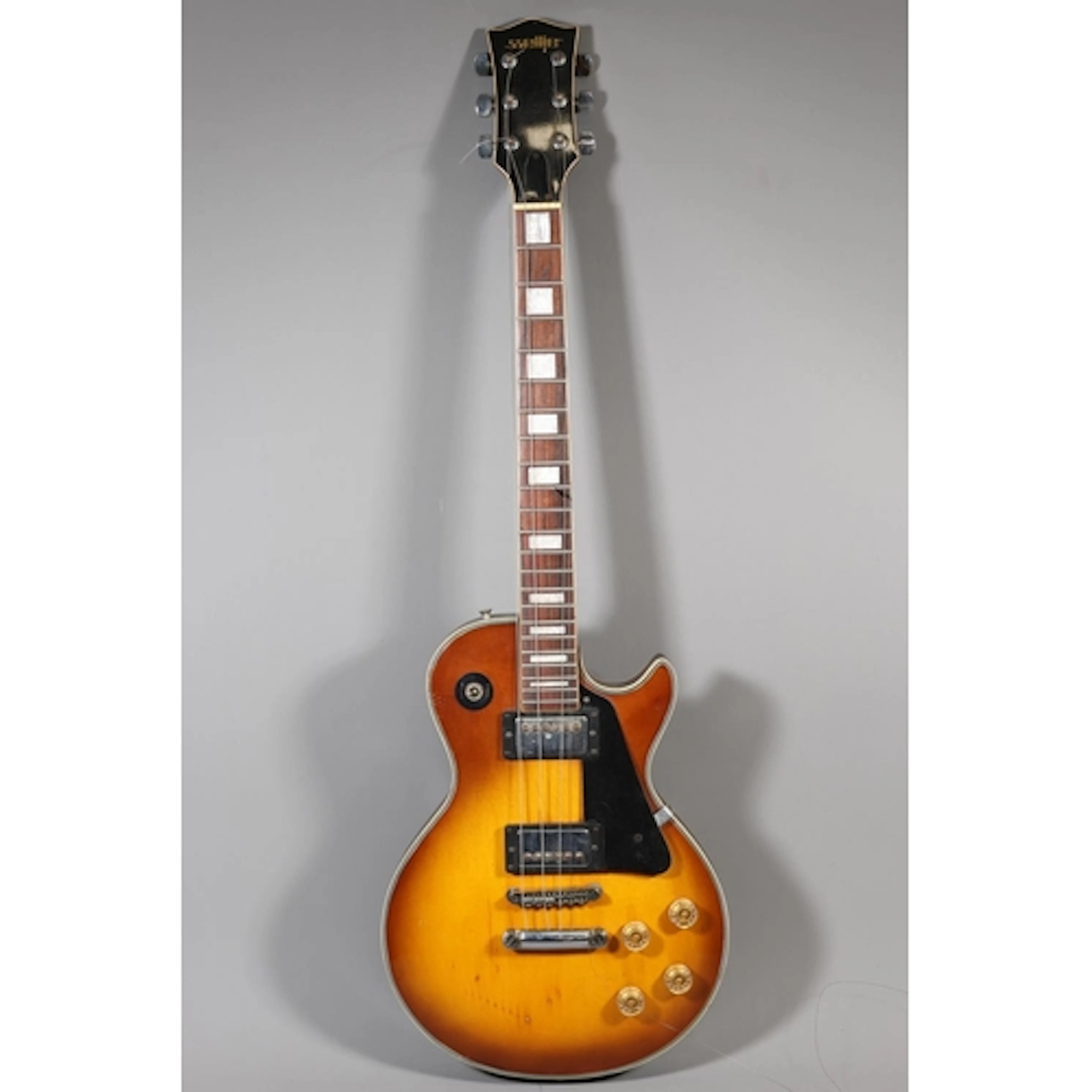 Satellite electric guitar with natural and black finish.