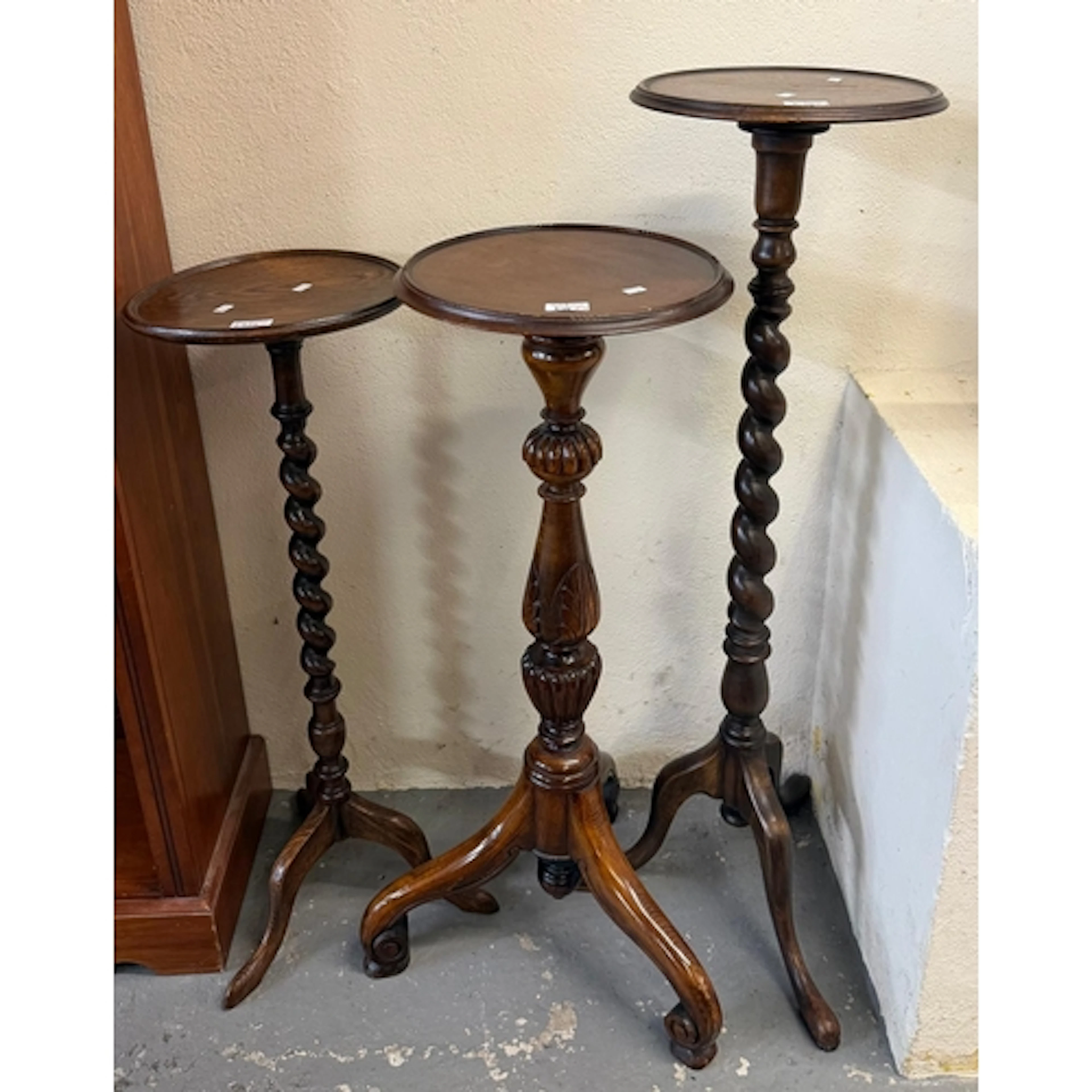 Three similar torchere stands, two with barley twist pedesta...