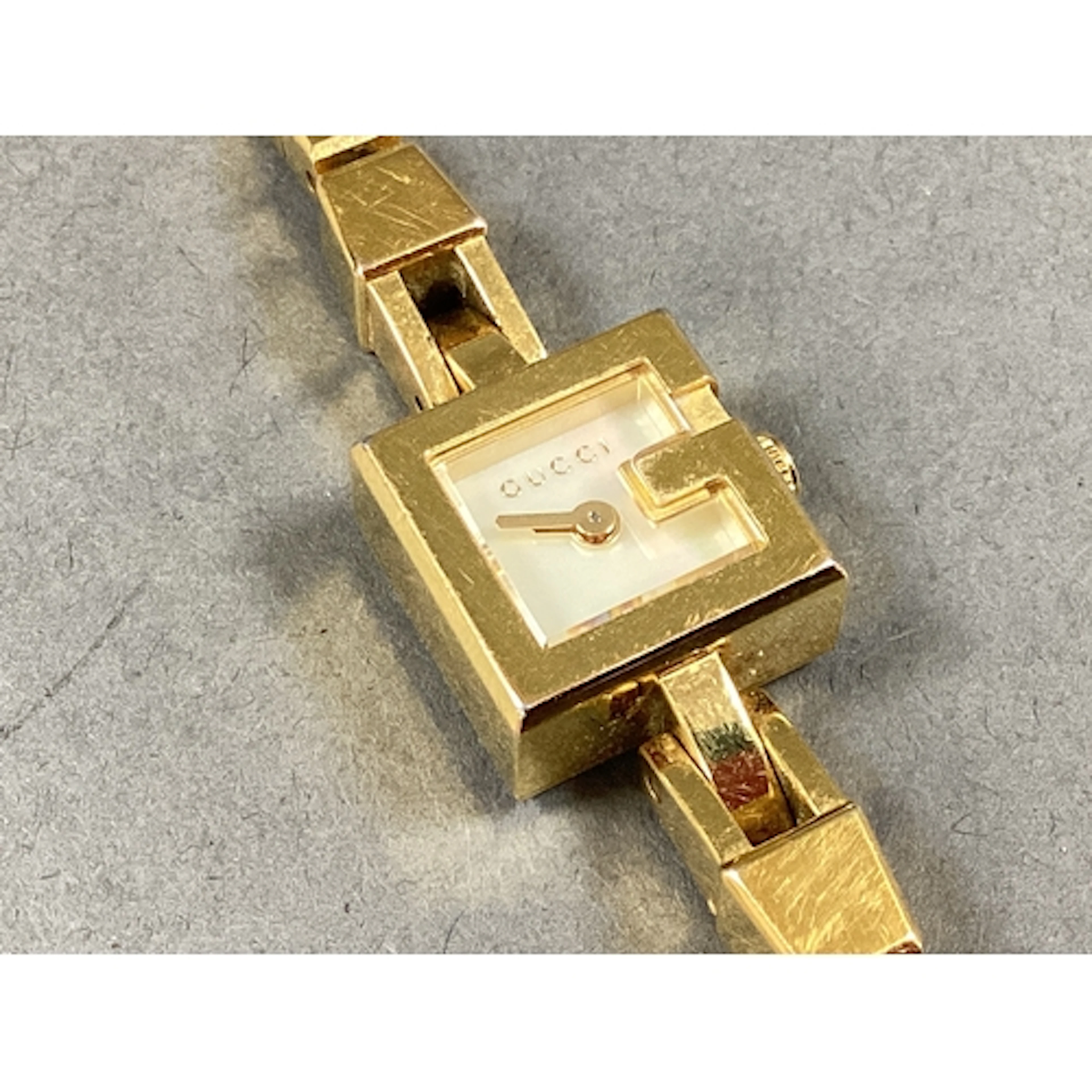 Gucci Mini G; A Gilt Coloured Ladies Wristwatch, the square ...