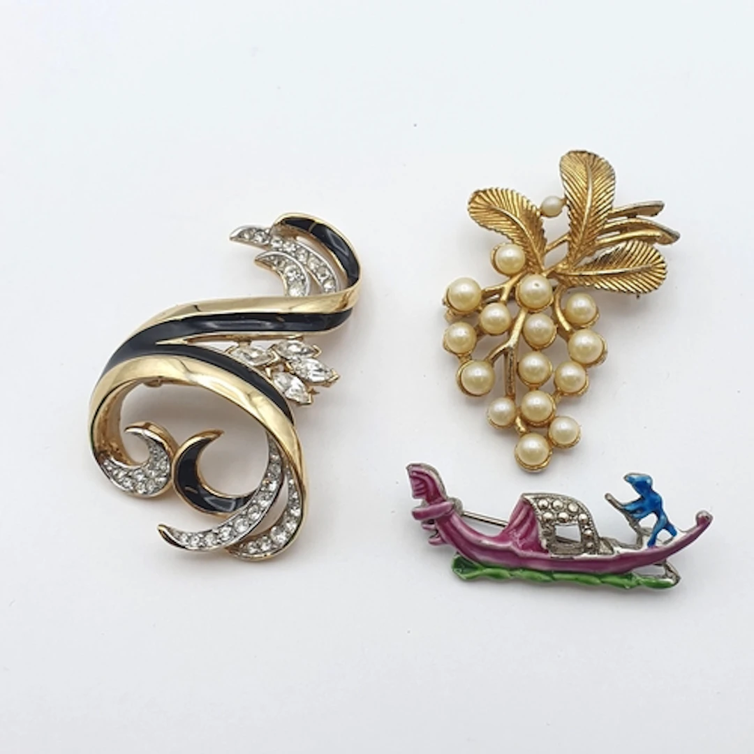 Two Hollywood Brooches, one of a gondola with enamel decorat...