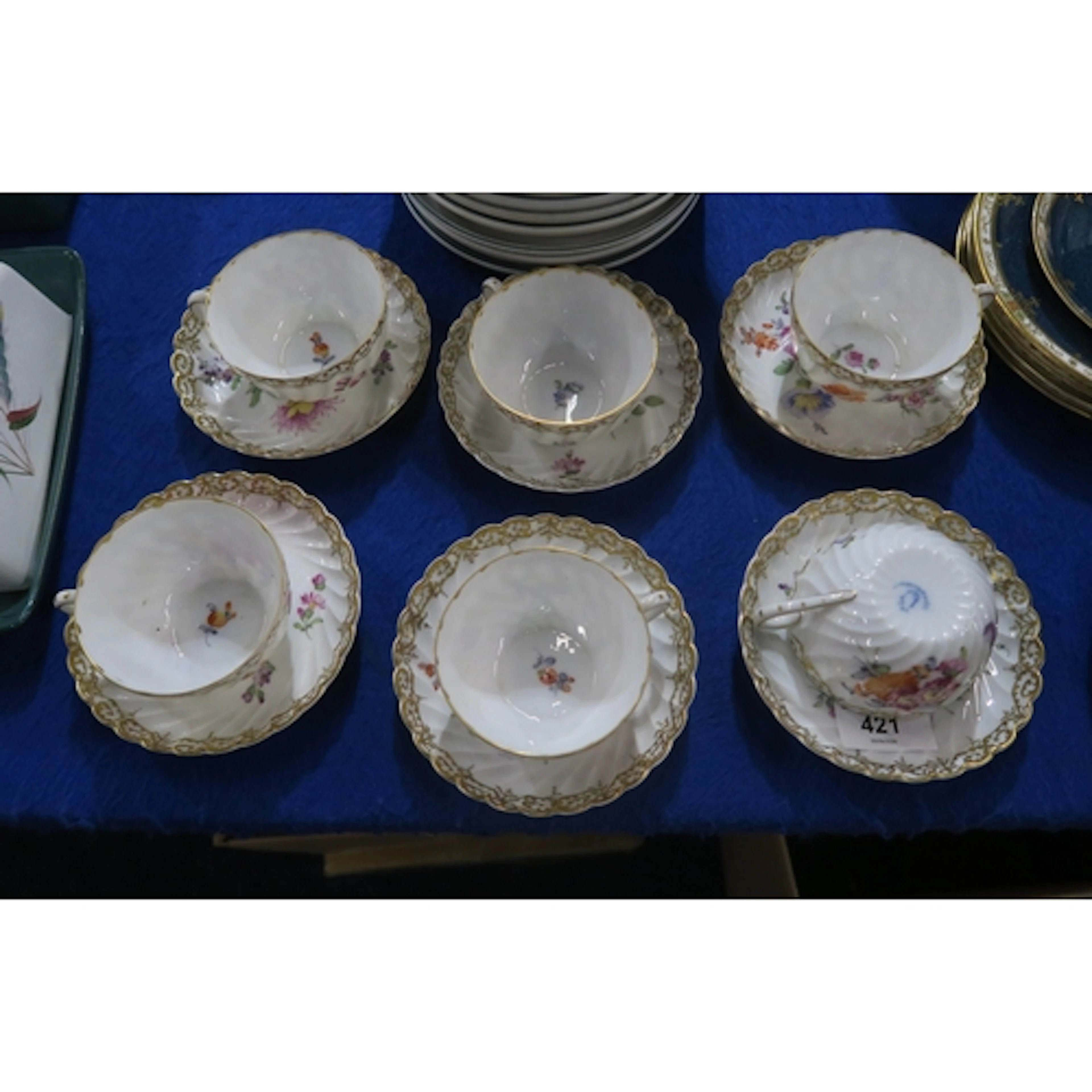 Six Nymphenburg cups and saucers painted with flowers