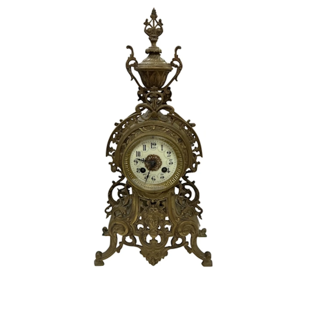 A French gilt-metal mantel clock, with pierced foliate desig...