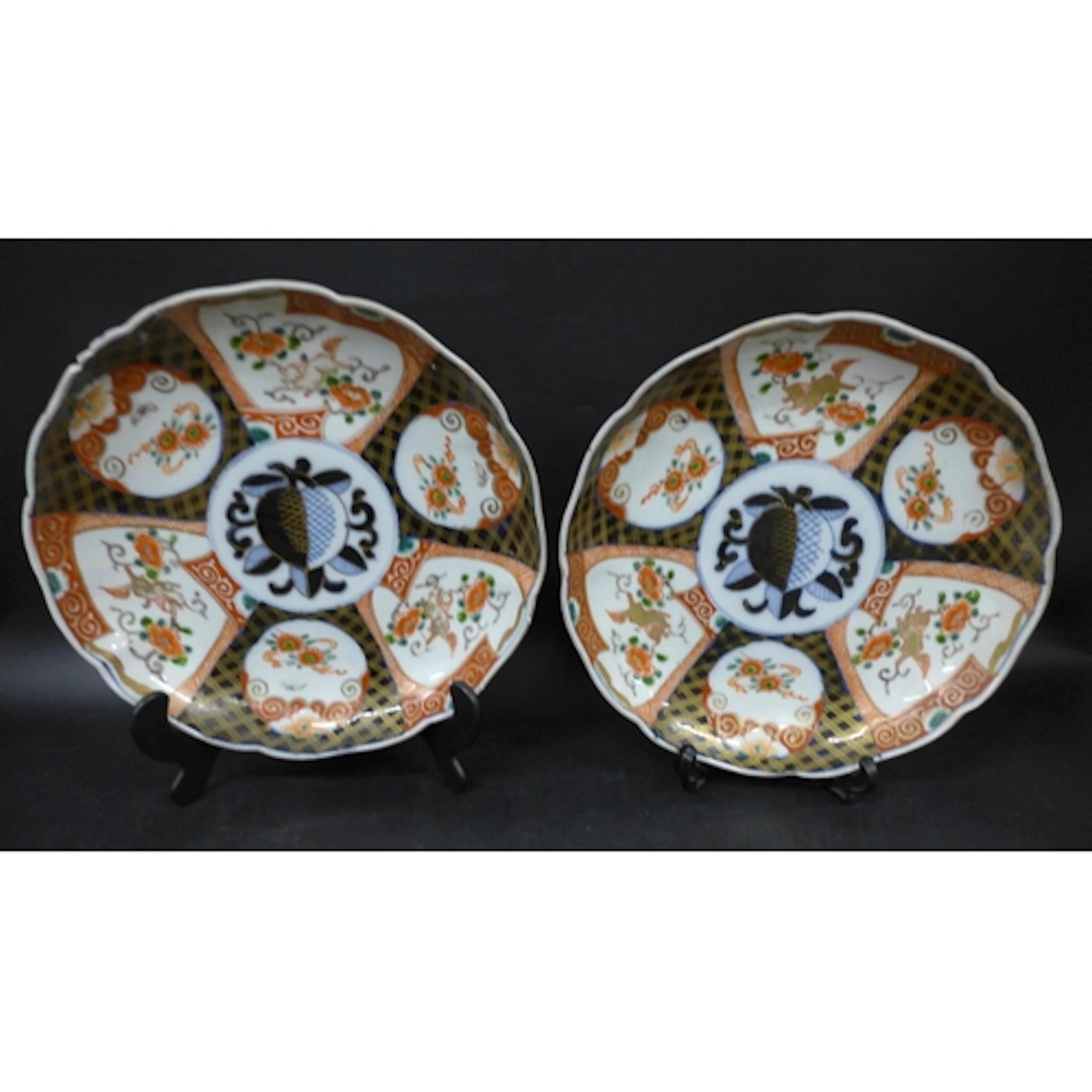 A pair of Japanese ceramic plates, hand painted repeated flo...