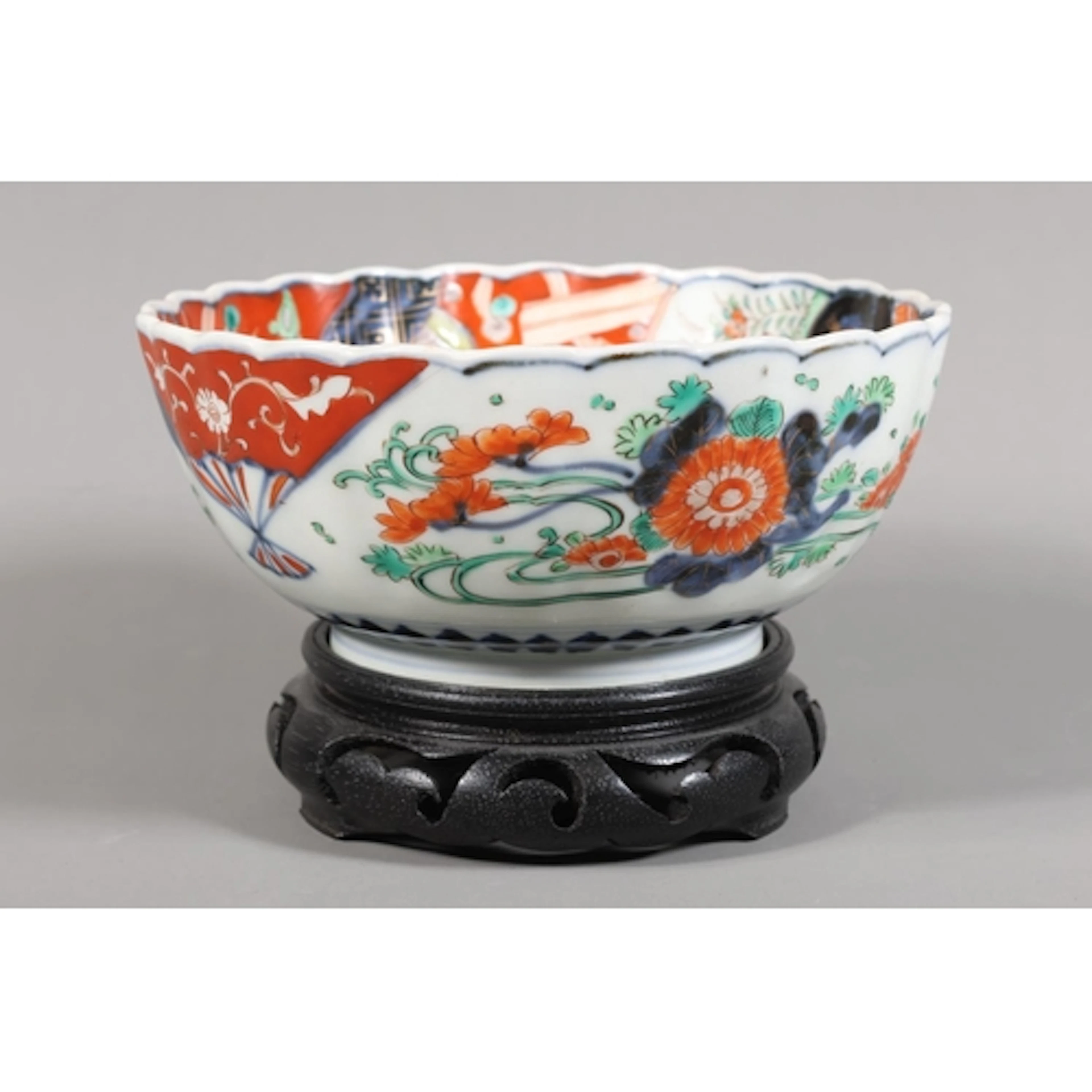Japanese Imari bowl decorated with traditional scenes, on st...