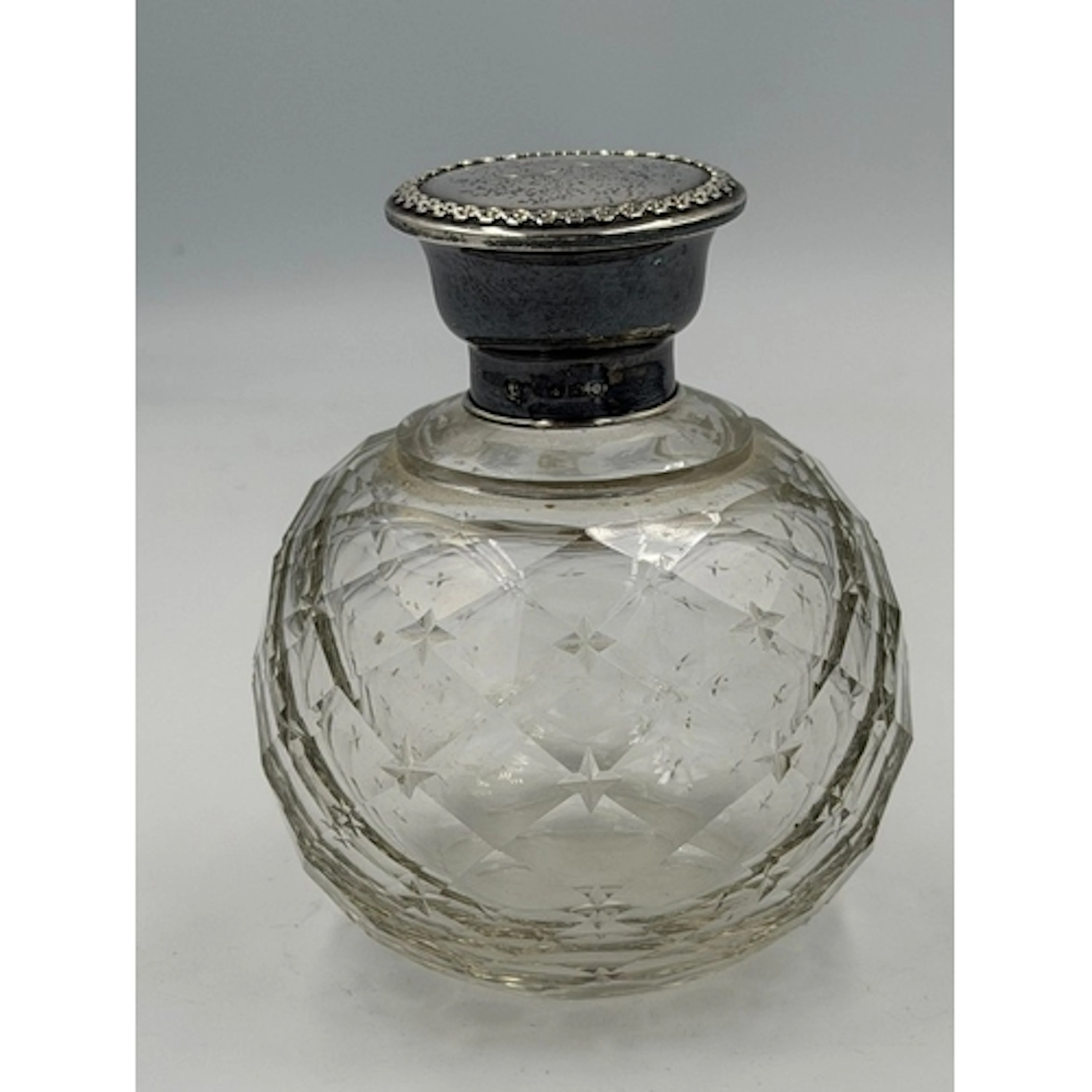 A silver mounted cut glass scent bottle, hallmarked for Birm...