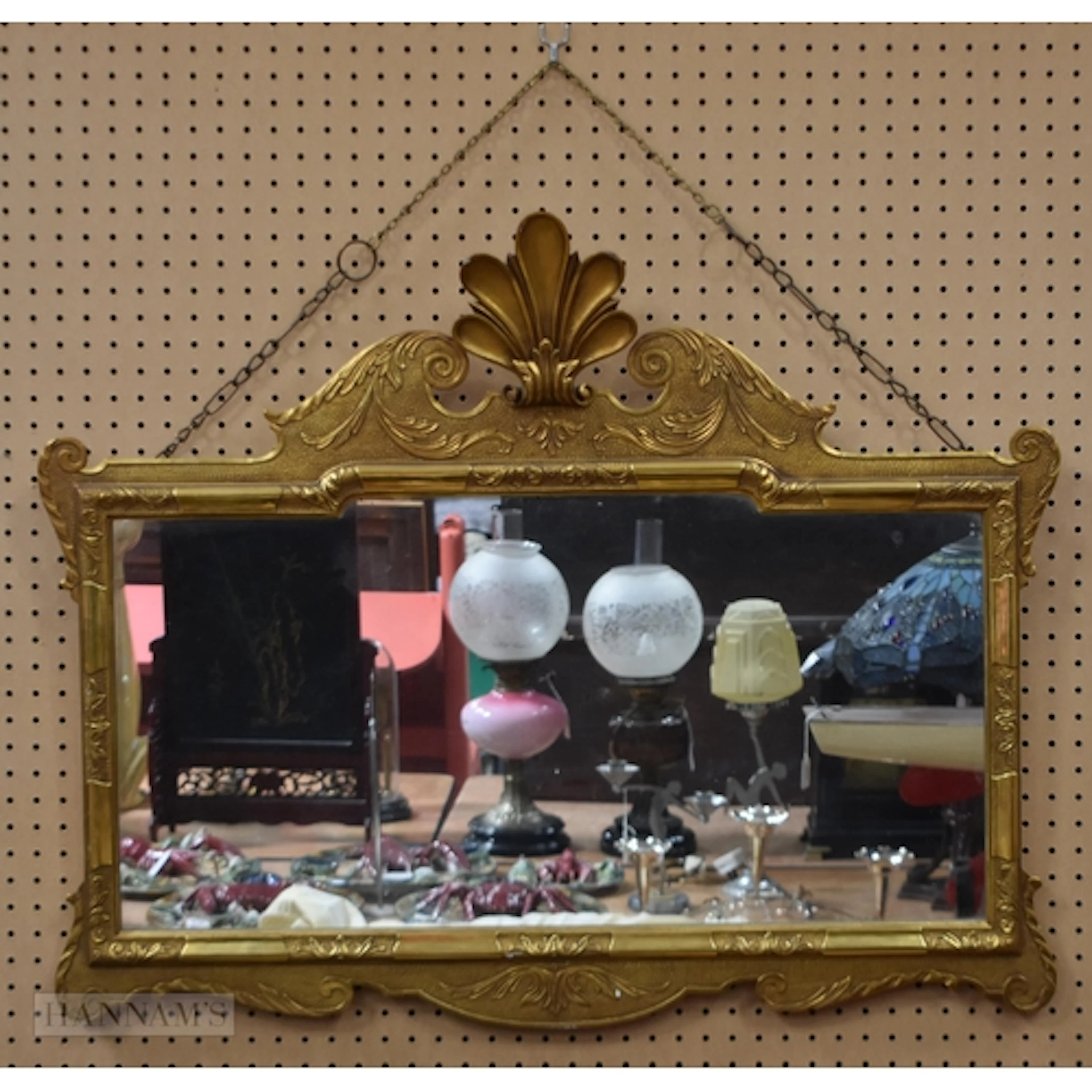 An antique gilt wood and plaster ornate mirror in the Rococo...