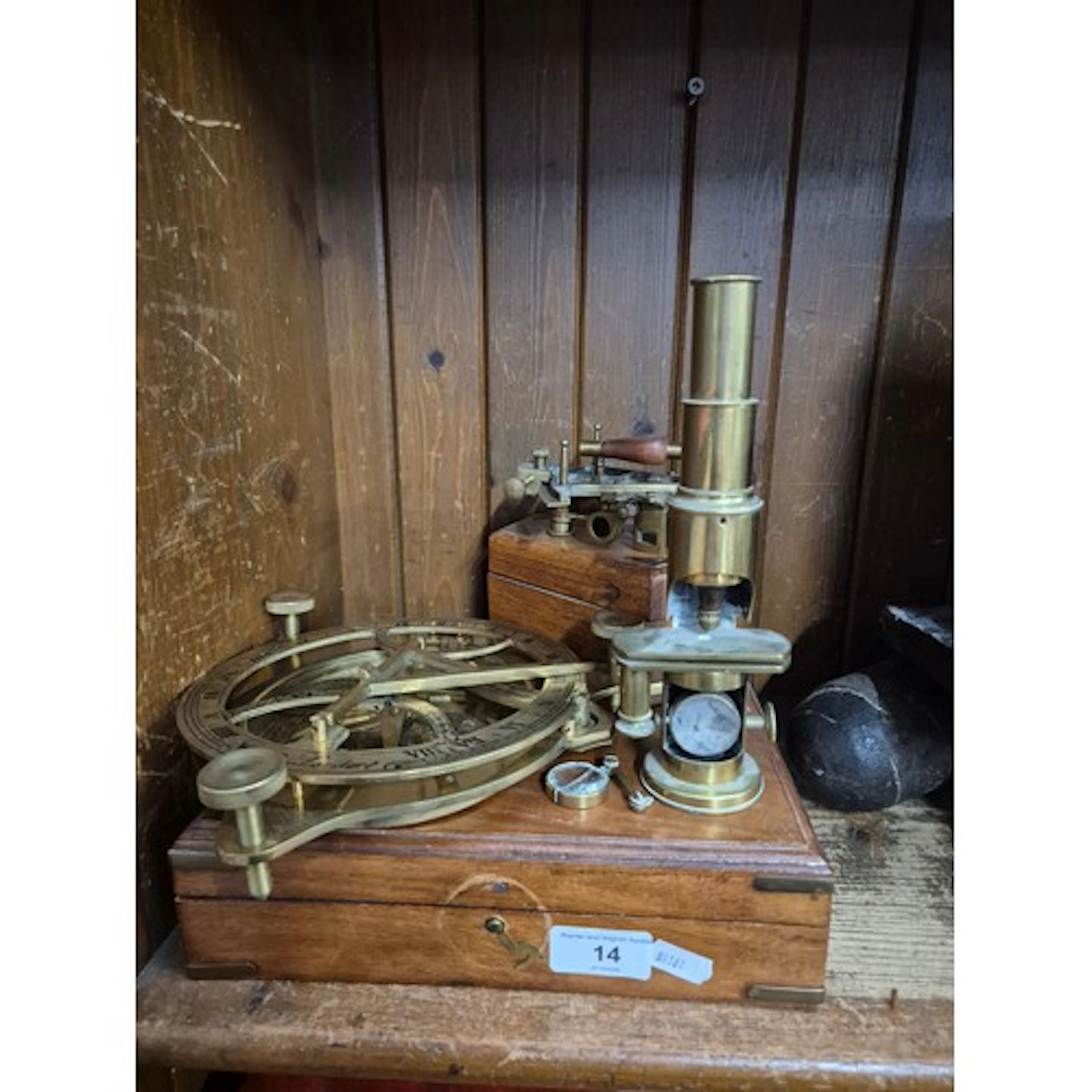A brass microscope, a marine sextant, and a brass nautical s...