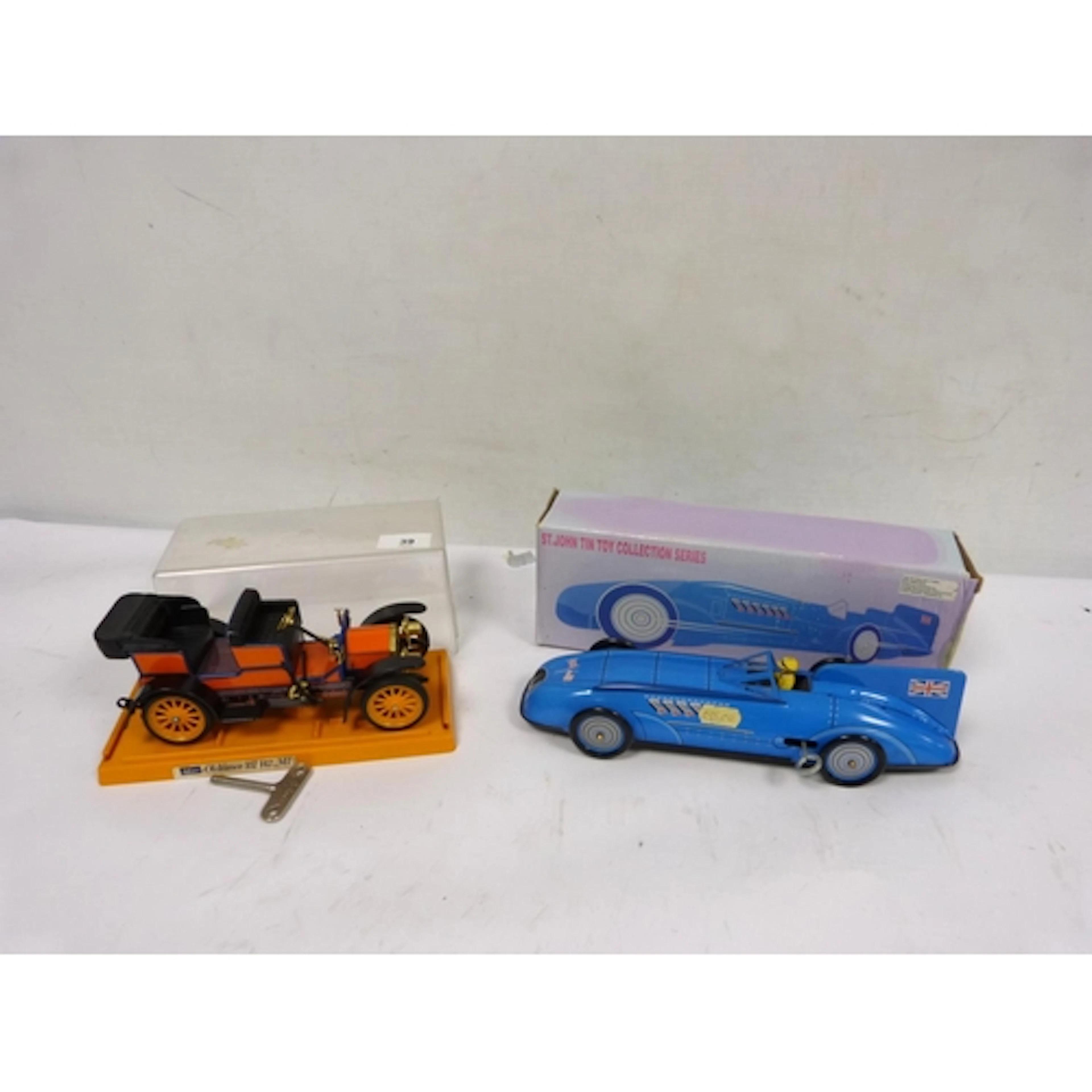 Two clockwork cars to include Schuco Oldtimer and St.John ti...