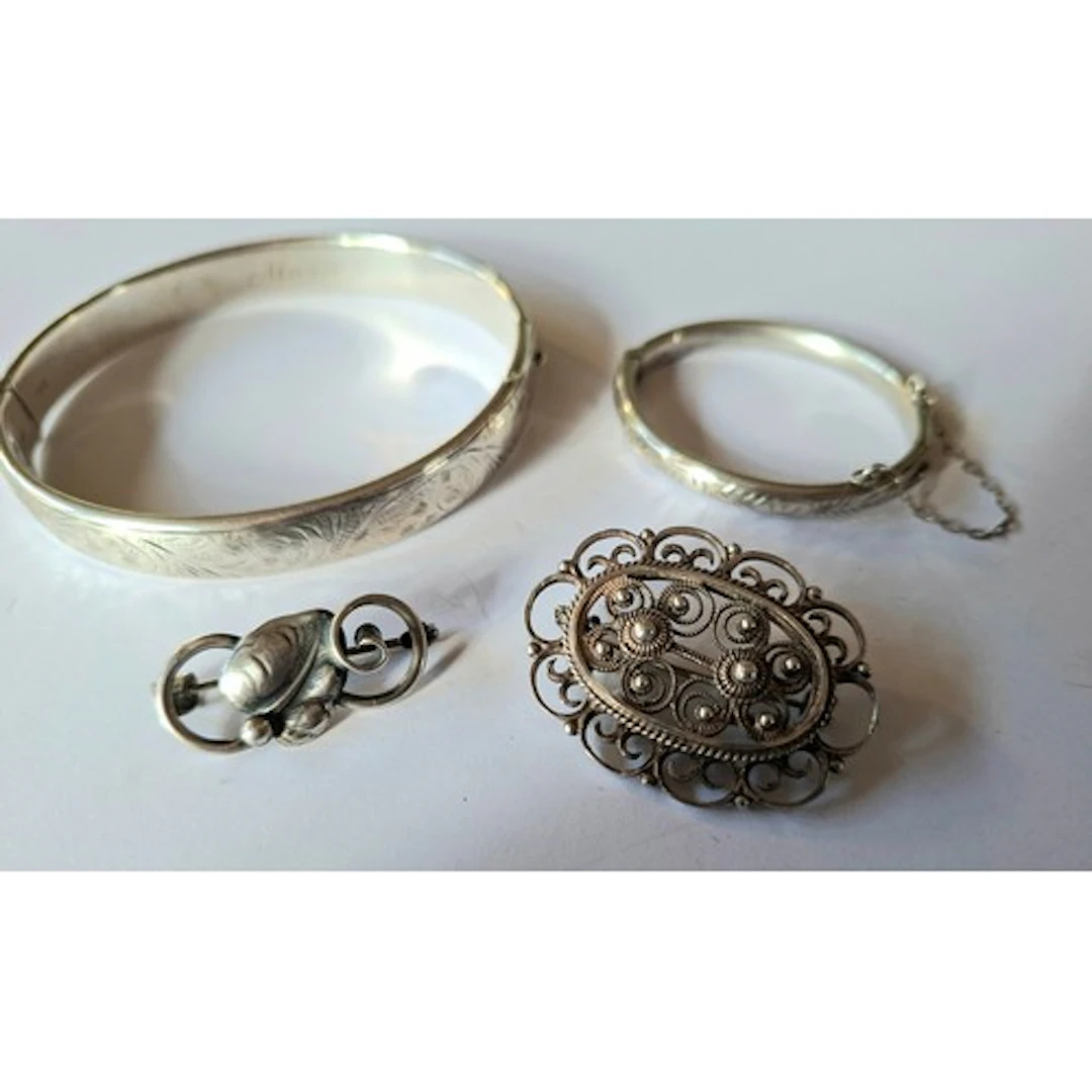 Four silver items comprising a Charles Horner engraved hinge...