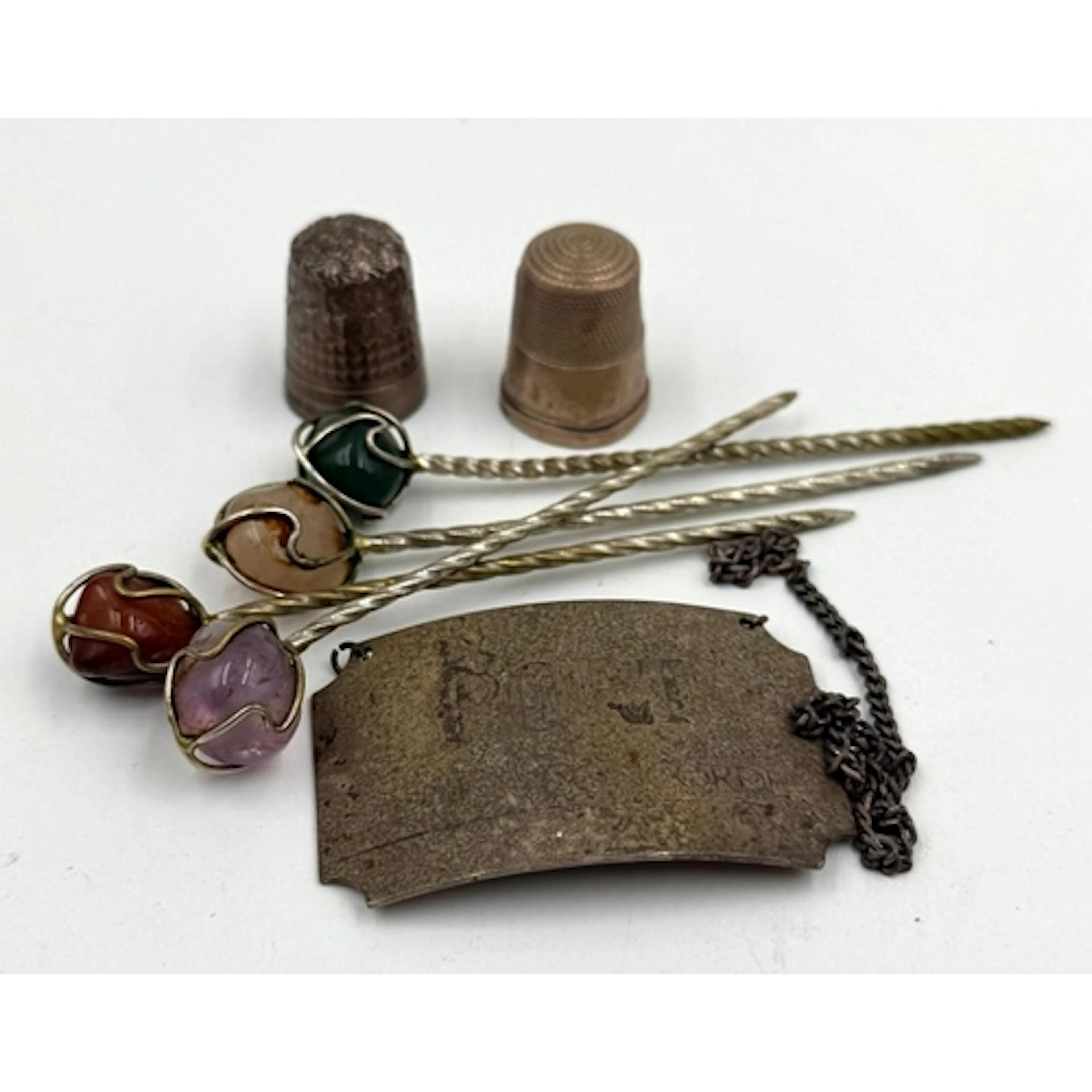 A small selection of silver curios to include two thimbles, ...