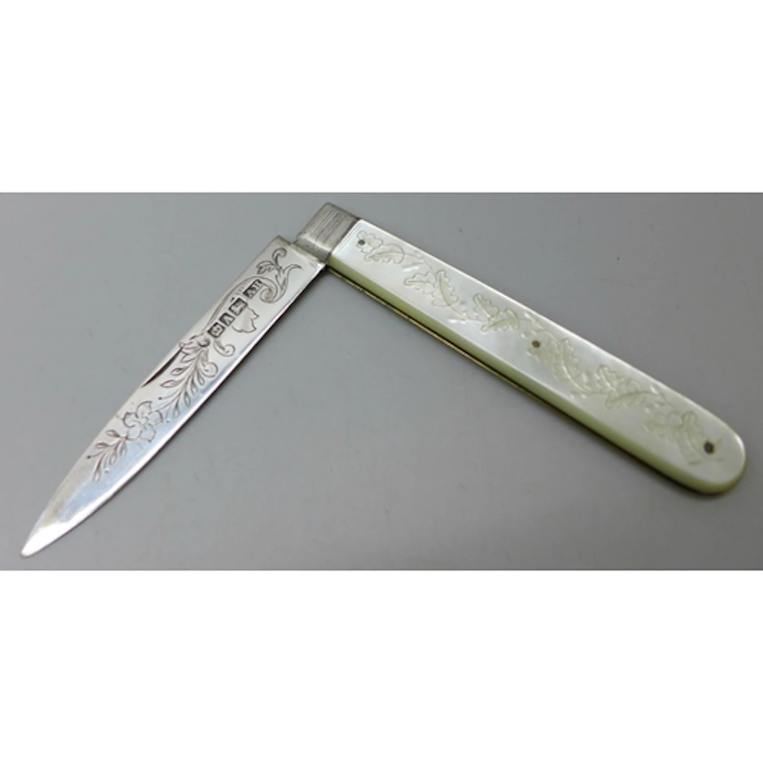 A Victorian carved mother of pearl fruit knife with a silver...