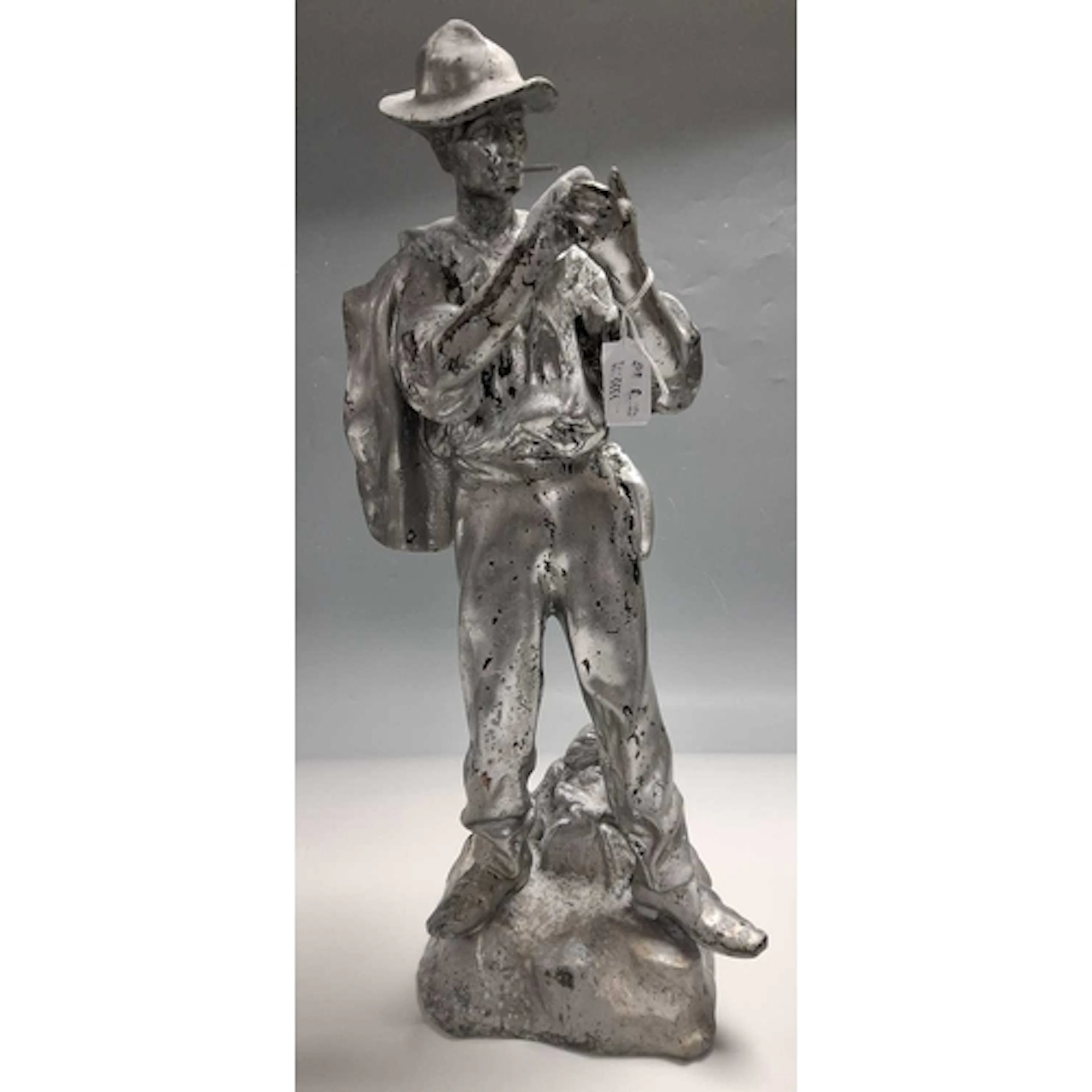 A METAL FIGURE OF A MAN, possibly a tobacco advertising figu...