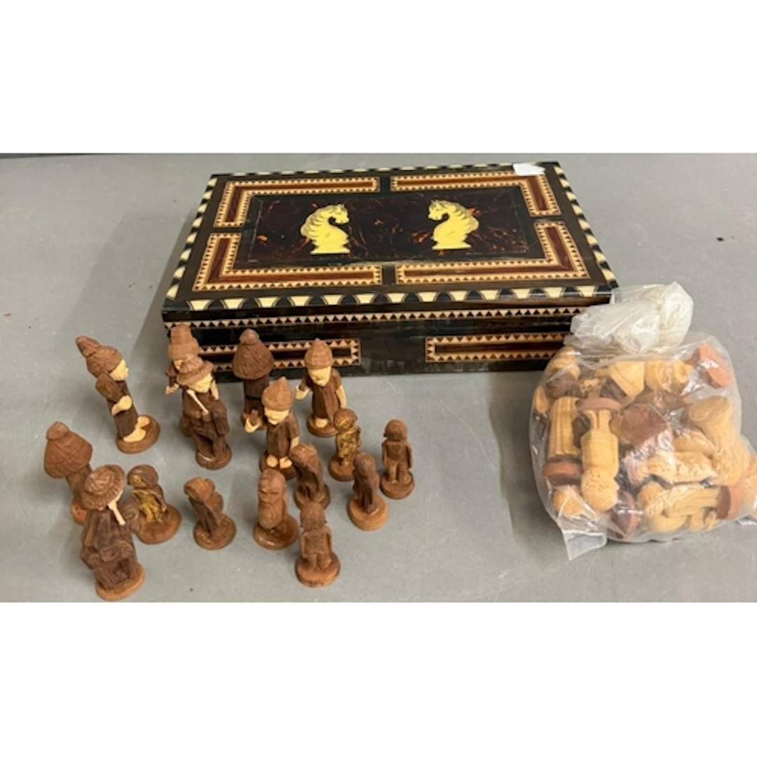 A marquetry chess box along with wooden figural chess pieces...
