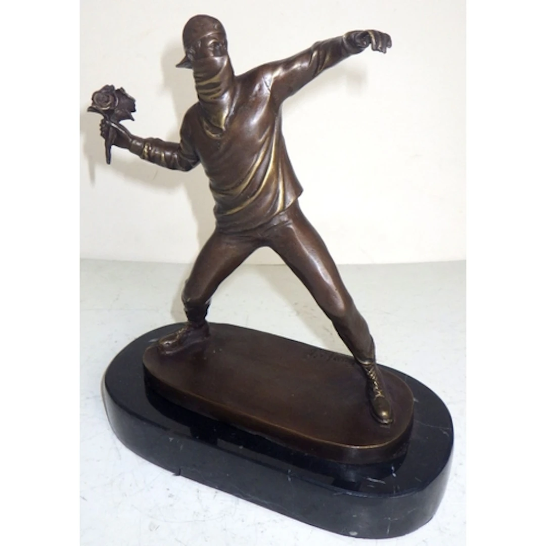 A “Banksy” flower thrower bronze figure, 25cm tall