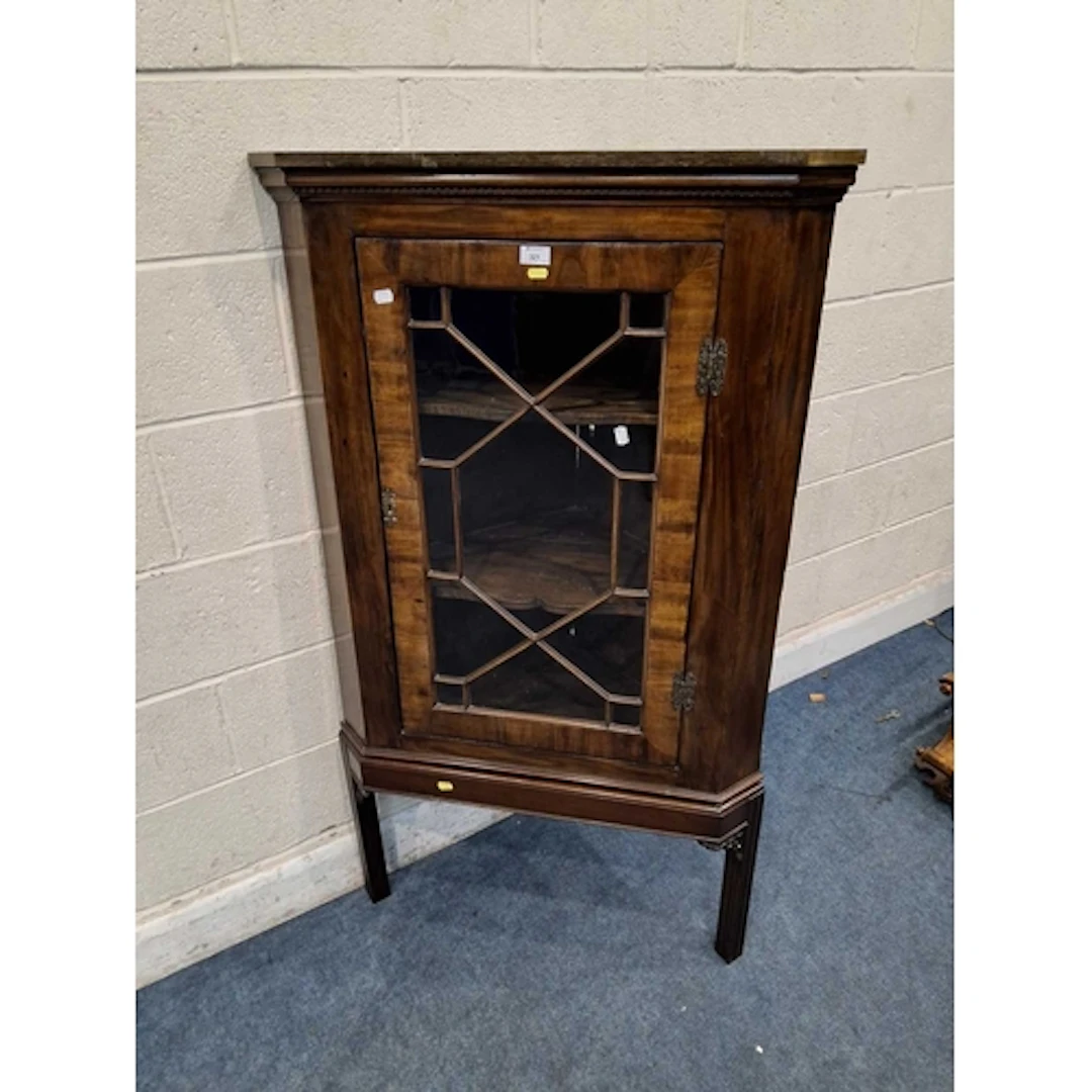 A GEORGIAN OAK CORNER CUPBOARD, with a single glass door tha...