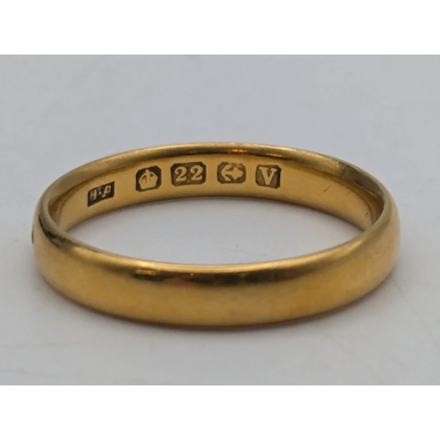 A 22ct yellow gold wedding band, stamped 22 with British hal...