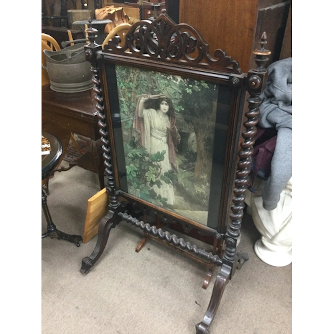 A Victorian fire screen with barely twist supports