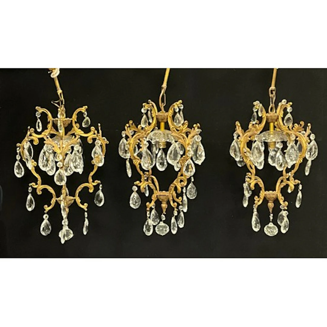 A trio of rococo revival brass chandeliers, with cut glass f...