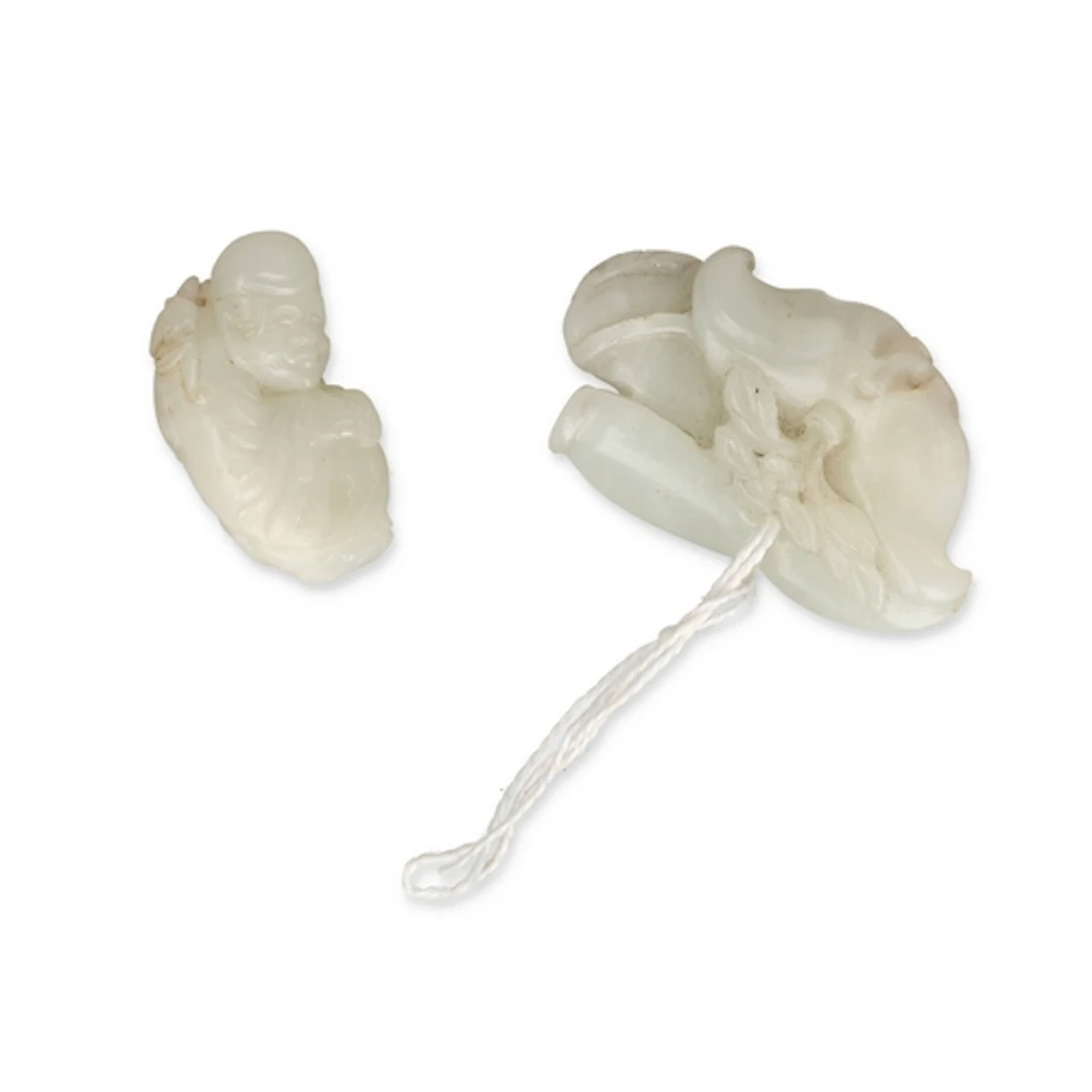 TWO CHINESE JADES One carved as a hunched figure, the other ...