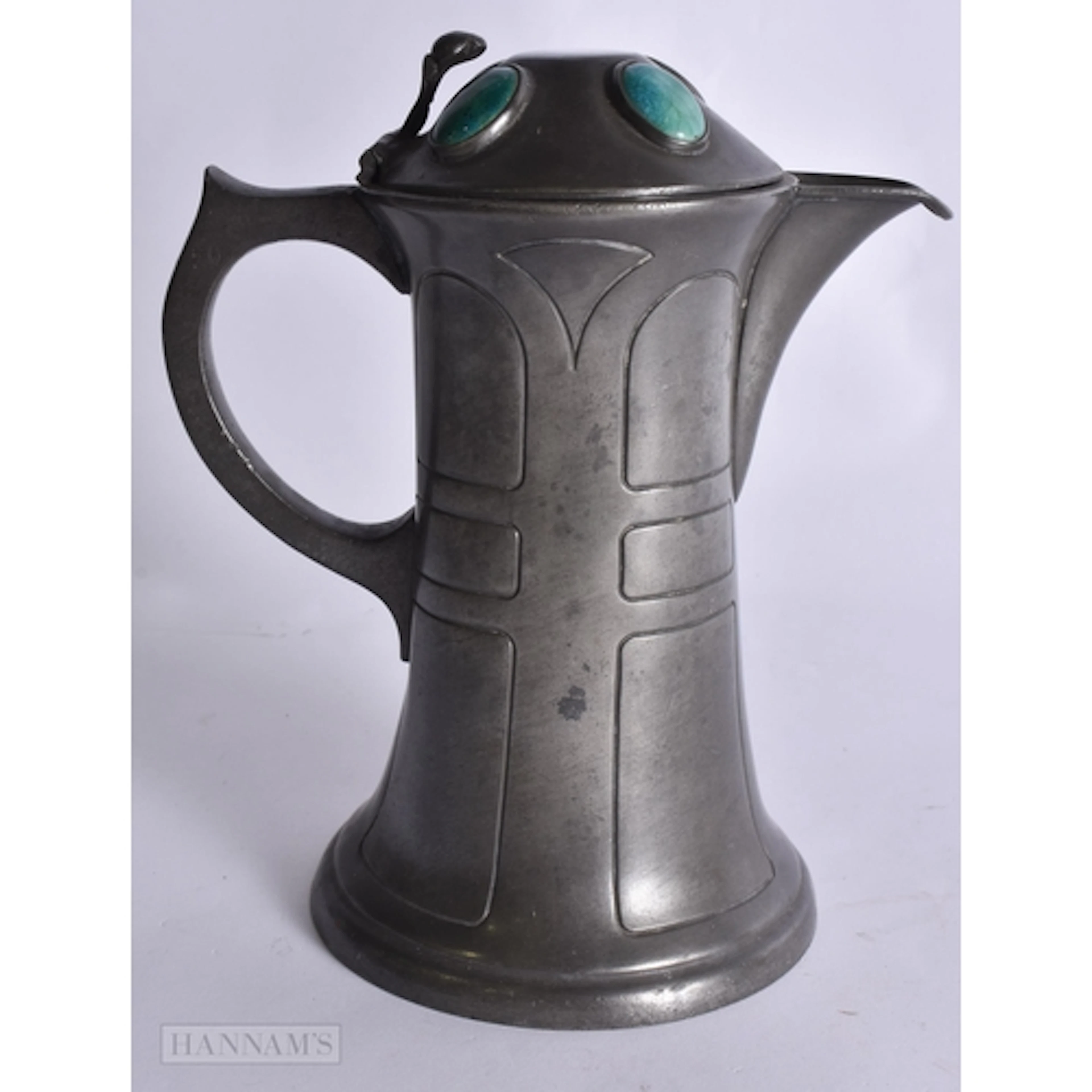 AN ART DECO PEWTER AND RUSKIN POTTERY JUG. 21 cm high.
