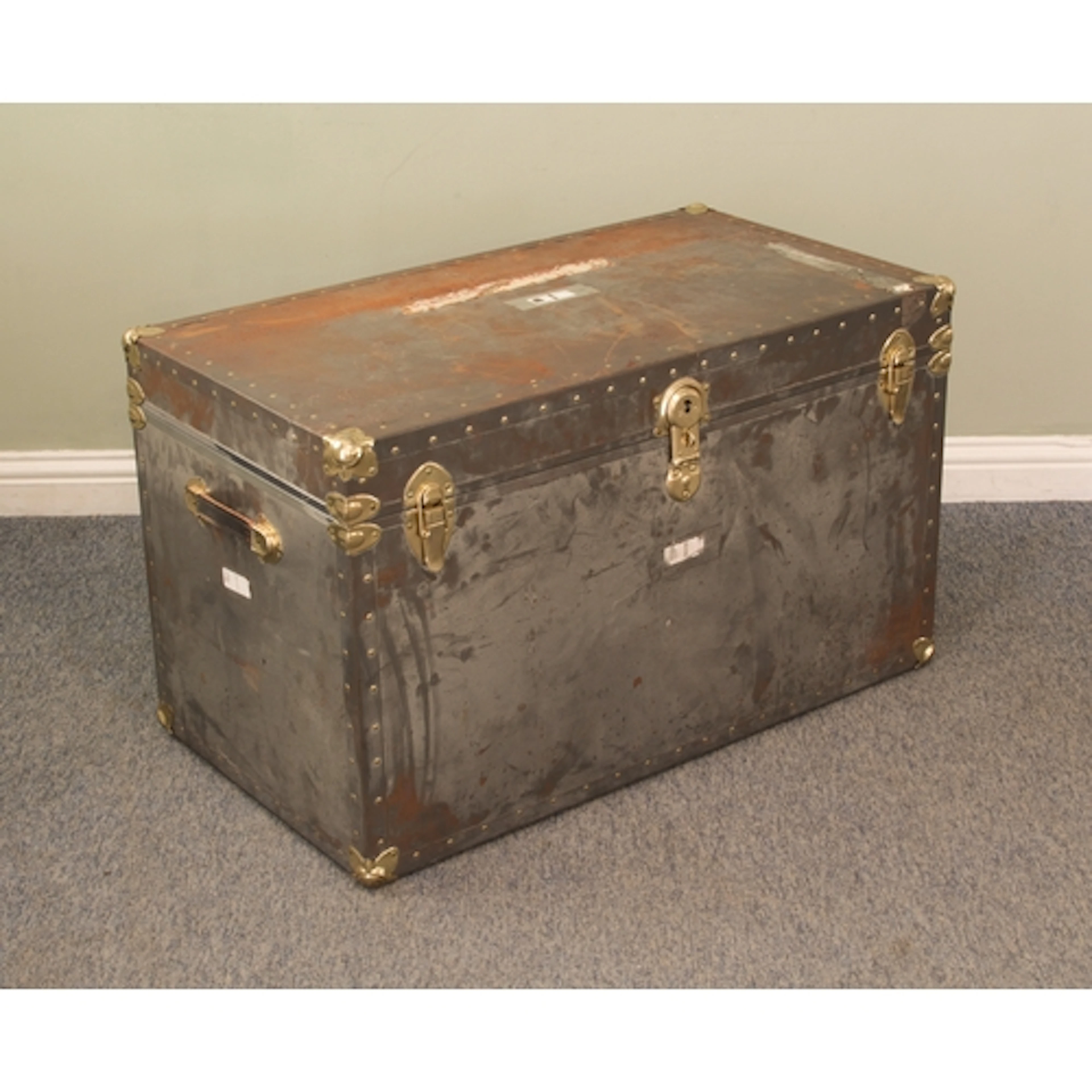 A large polished metal steamer or school trunk - with gold t...