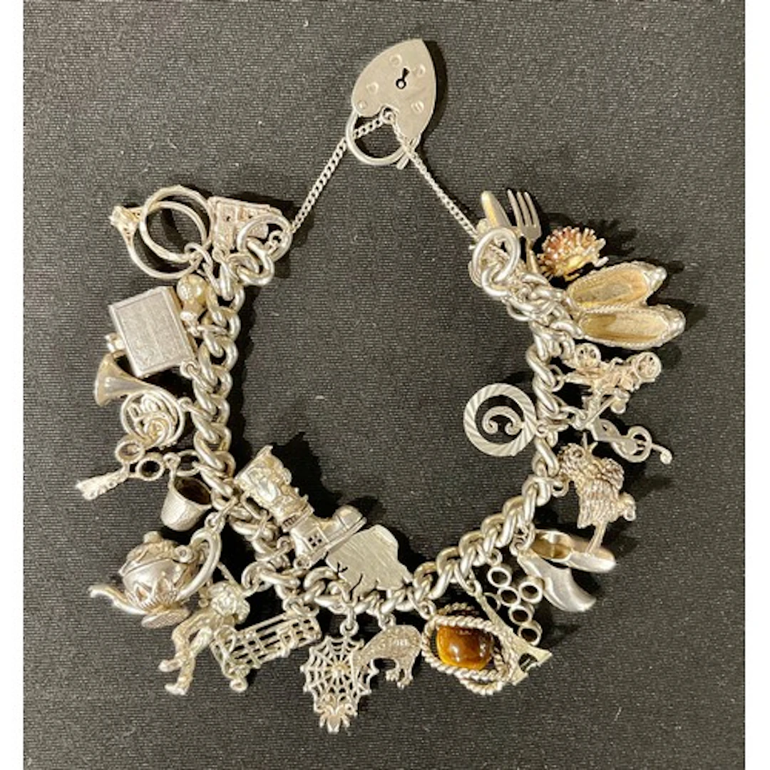 An Elizabeth II silver charm bracelet, the clasp hallmarked ...