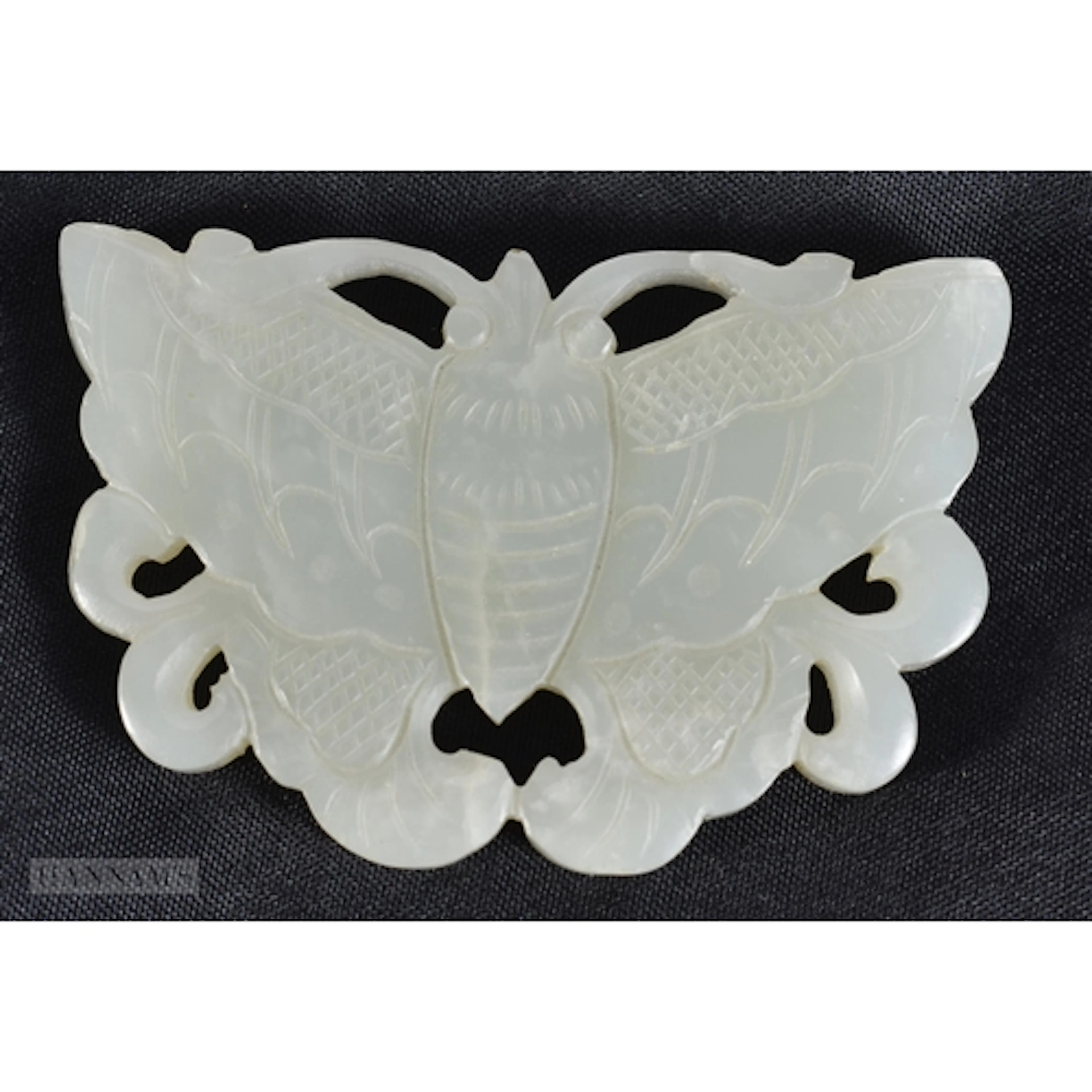 A CHINESE QING DYNASTY CARVED JADE PLAQUE formed as a moth. ...