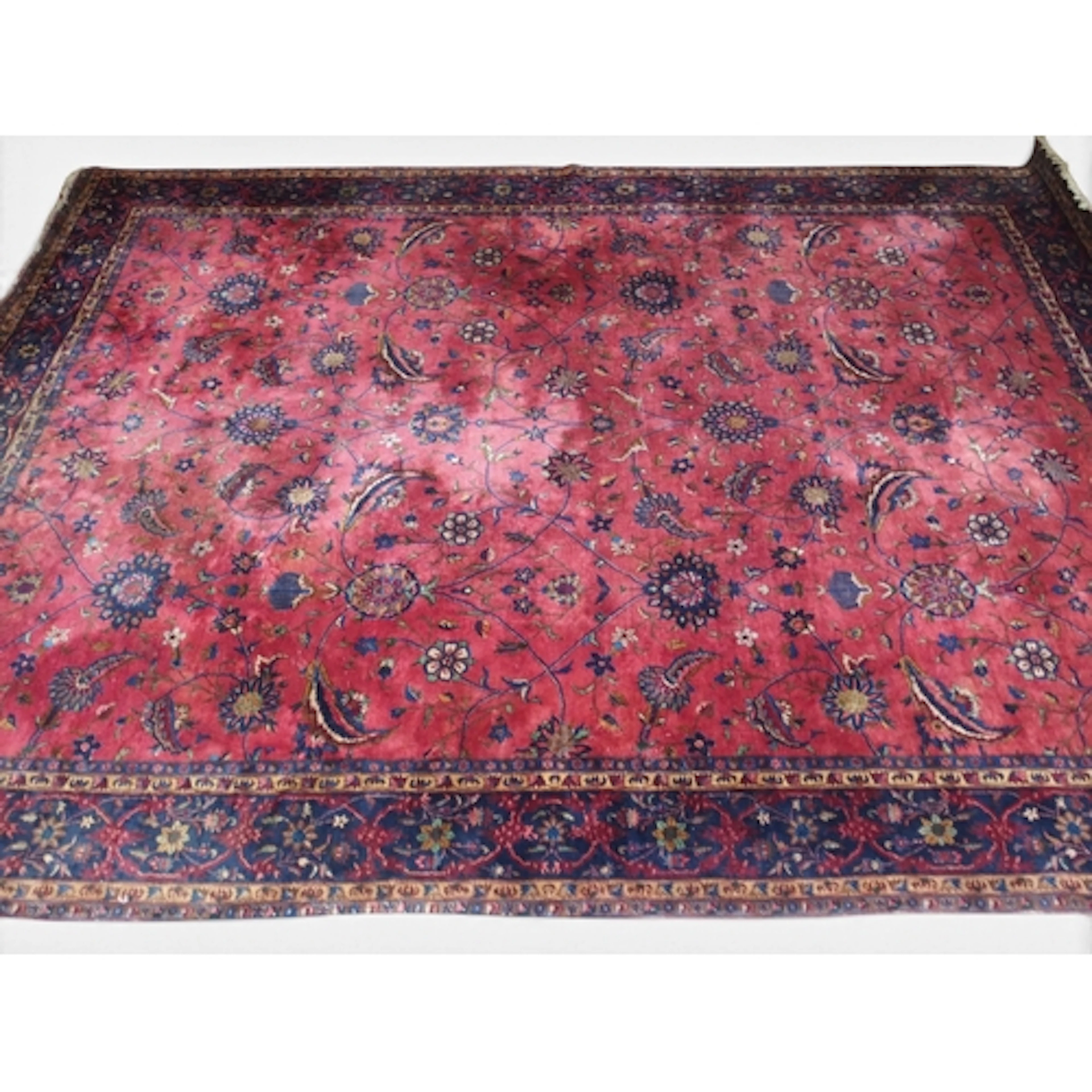 AN IMPRESSIVE LARGE RED GROUND SAROUK RUG with all-over flo...