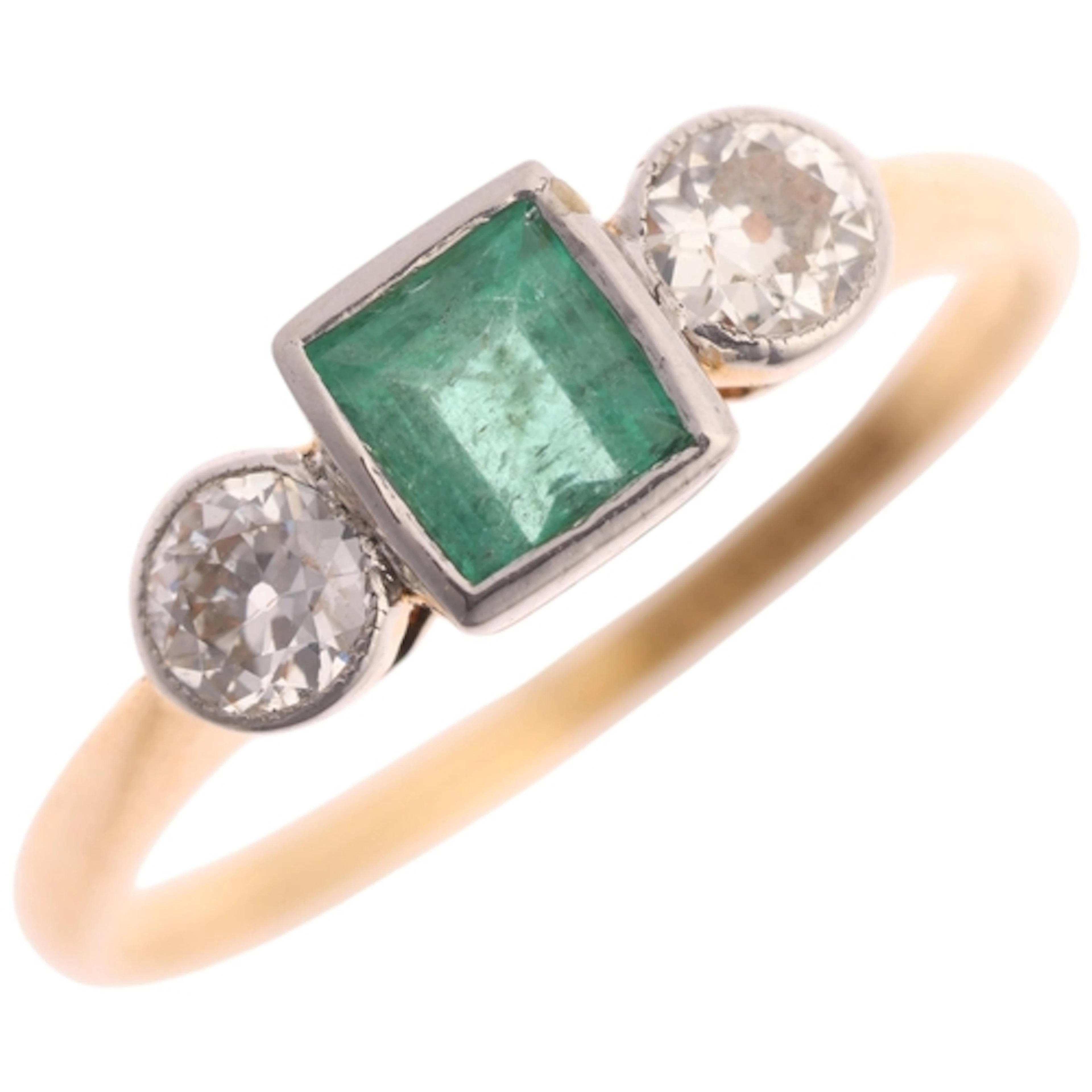 An 18ct gold three stone emerald and diamond ring, platinum-...
