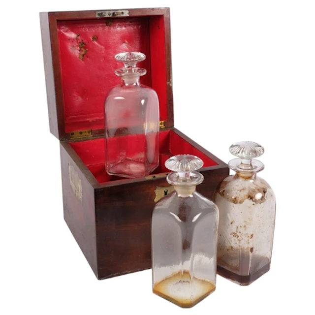 A Victorian mahogany decanter box, containing 3 of the 4 ori...