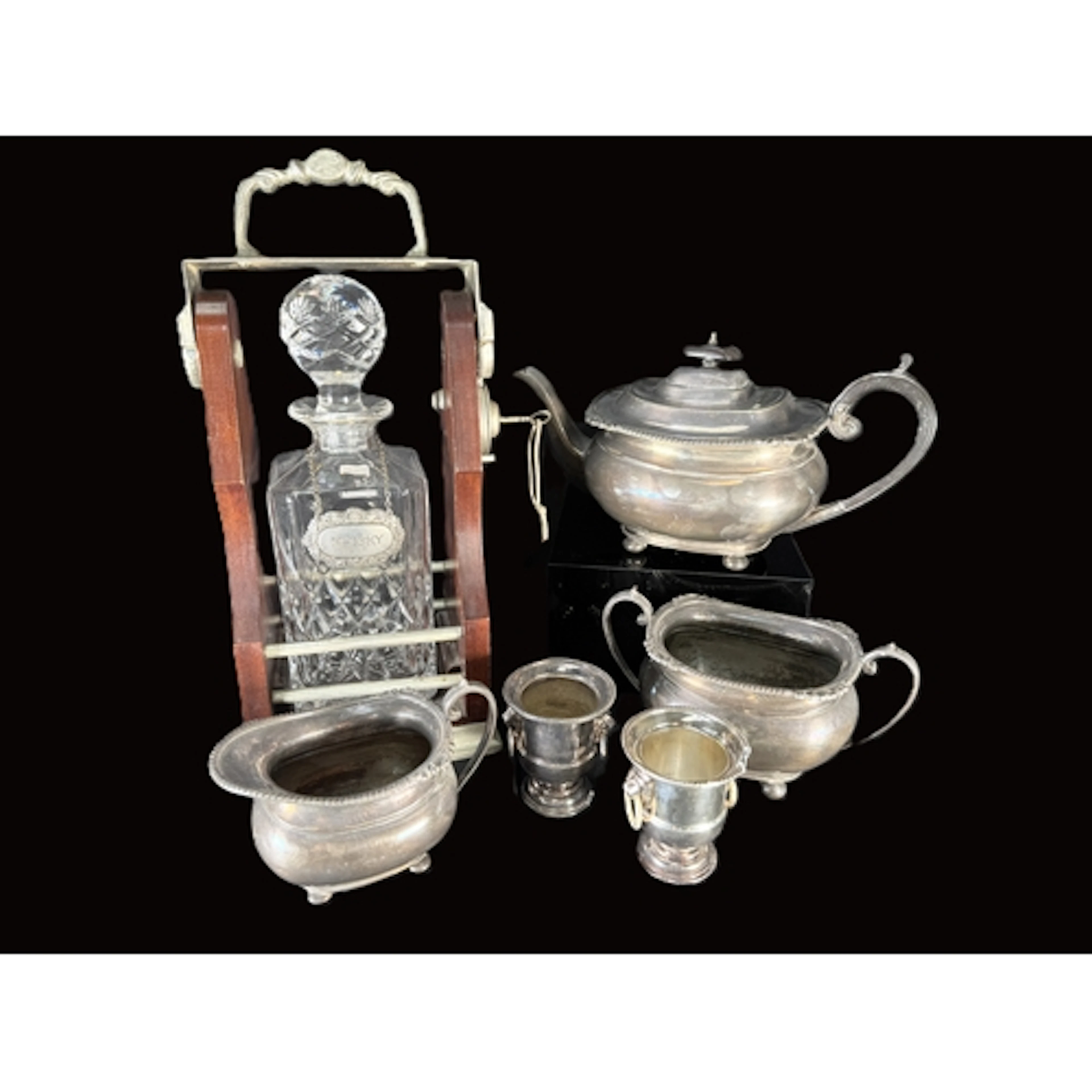 A 3 piece silver plated tea service; a singular Tantalus wit...