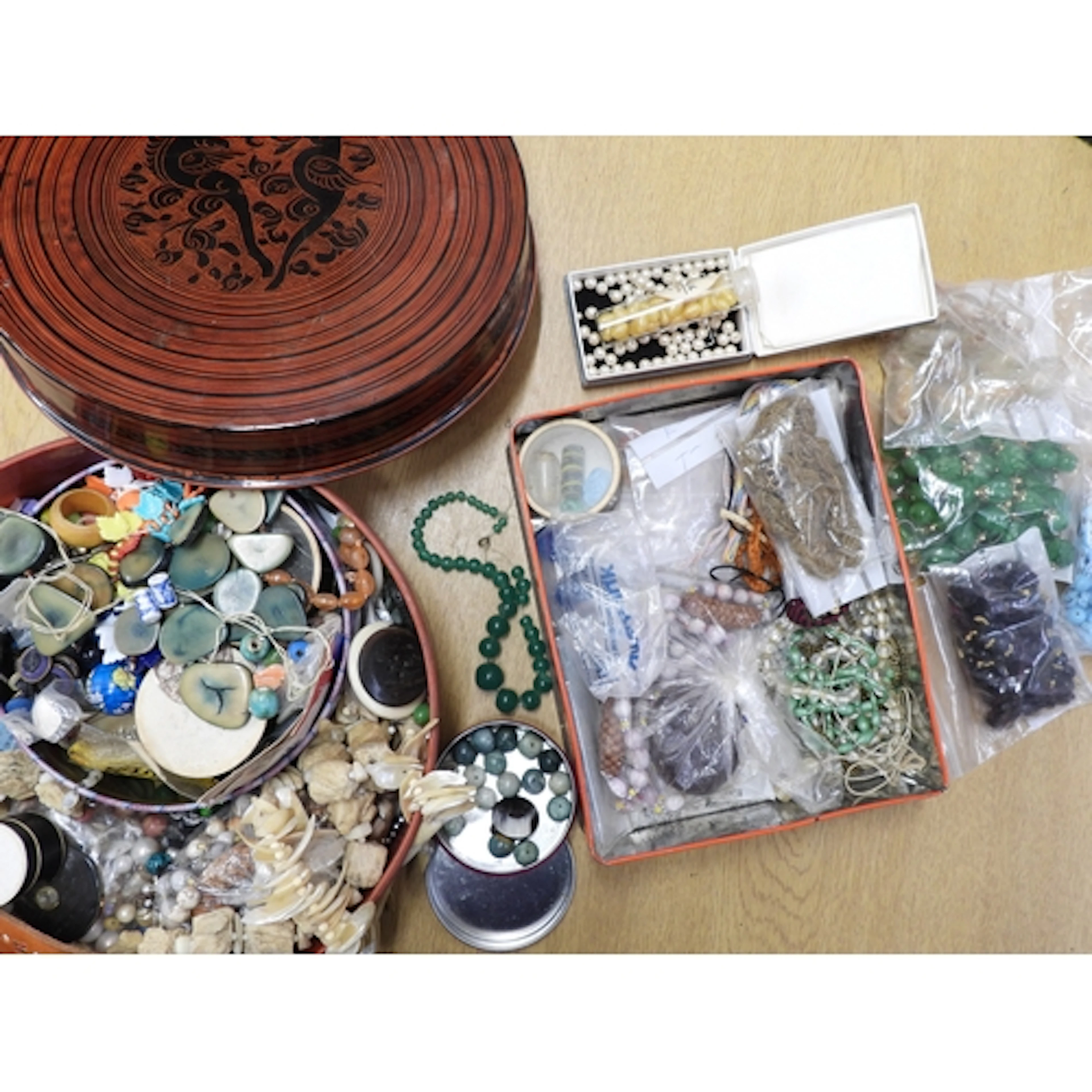 An Oriental lacquer box, and a tin filled with vintage beads...