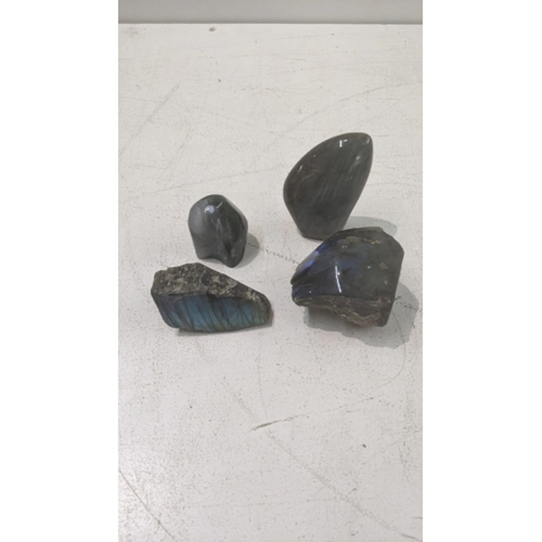 Four natural labradorite stones ranging in sizes Location: I...