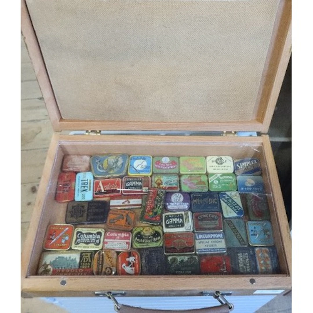 A box of vintage gramophone needle tins