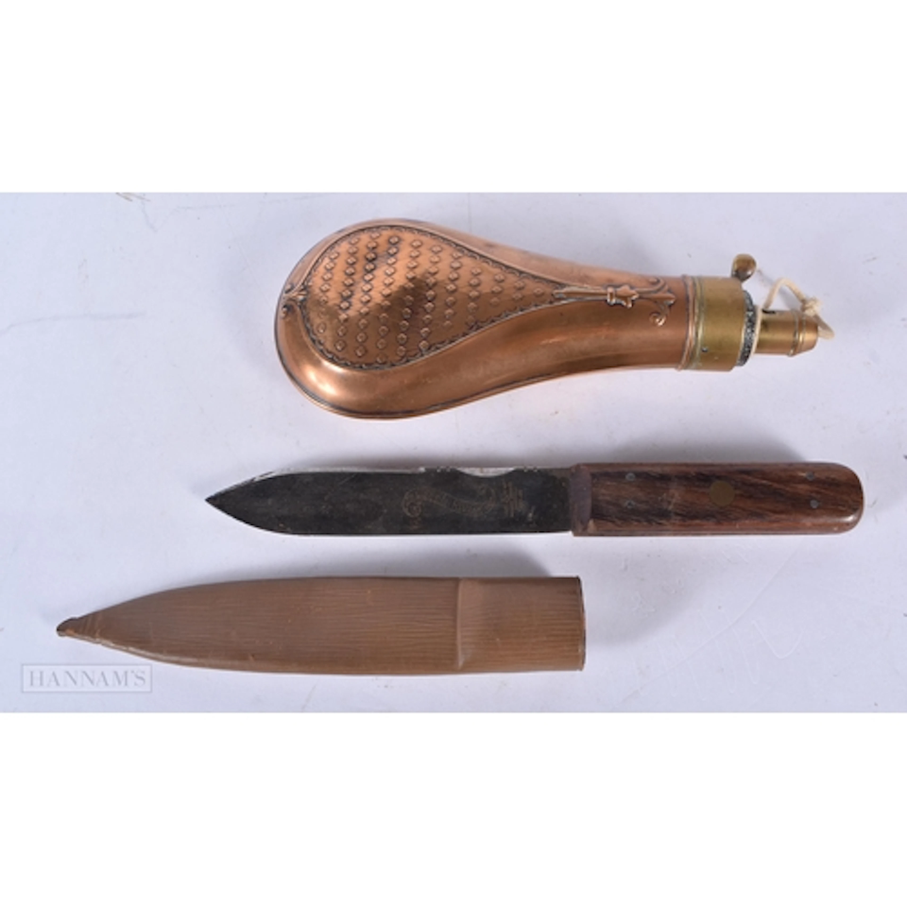 An antique copper and brass powder flask together with a gre...