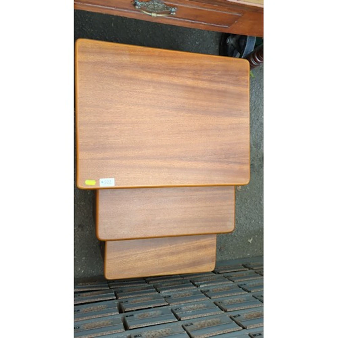 A nest of occasional tables with rectangular wood-veneered t...