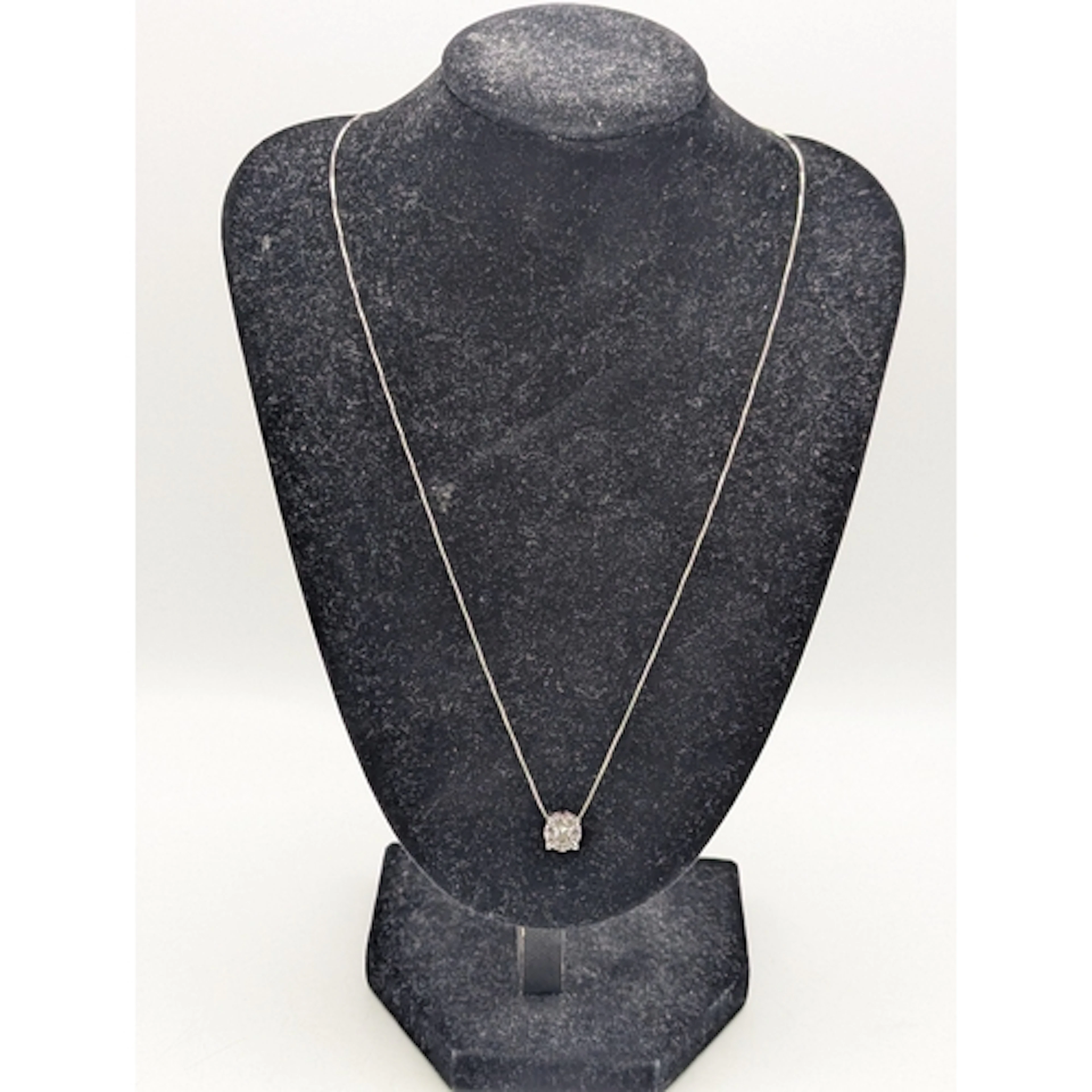 A diamond and 14ct white gold cluster pendant, set with a to...